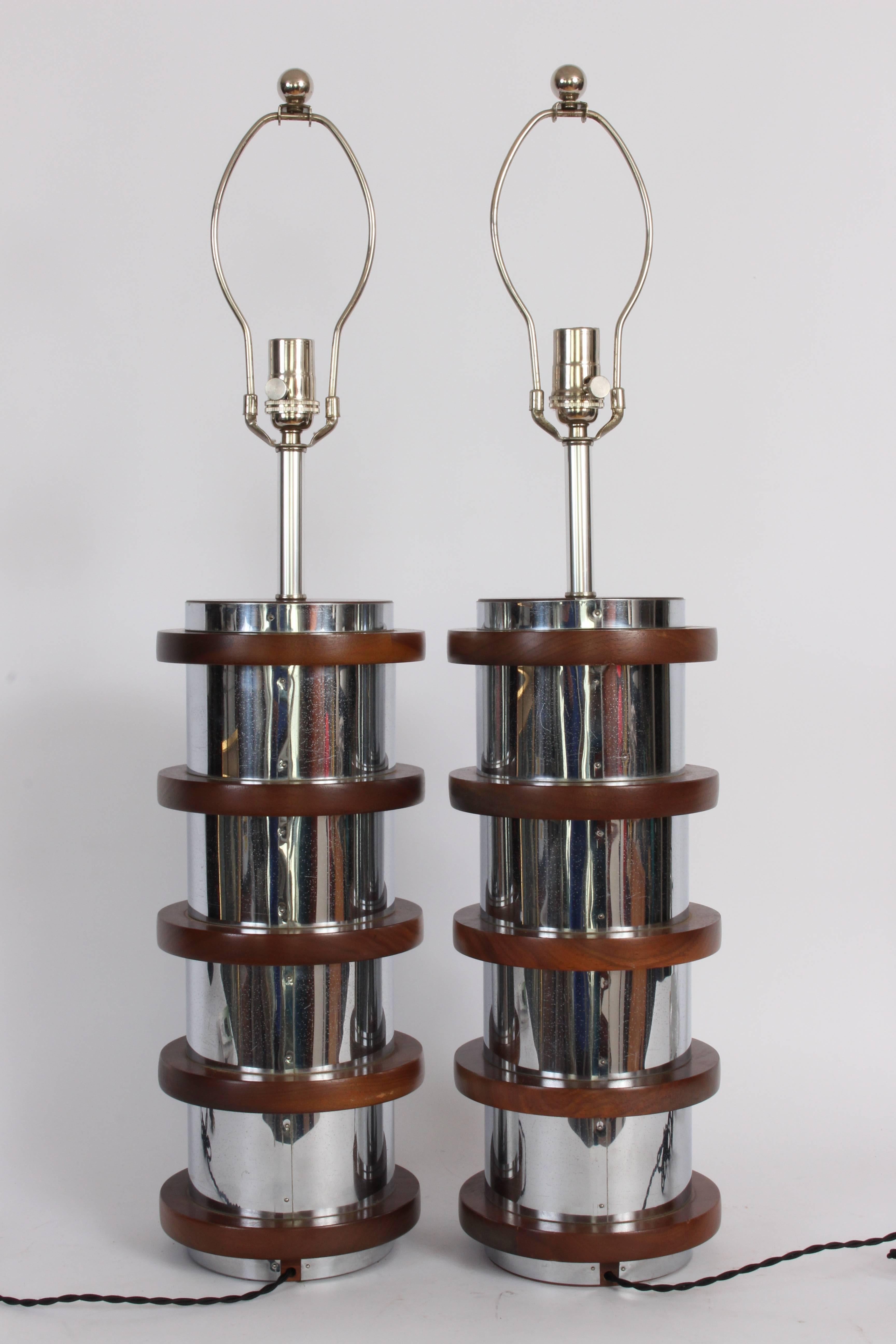 1960s Modern stacked Polished Chrome and Black Walnut Table Lamps. Featuring Chrome columns accentuated with Black Walnut rings. High tech. Handsome. Architectural. Reflective. Russel wright style. Statement lighting. 20 H Base. 25 H top of socket.