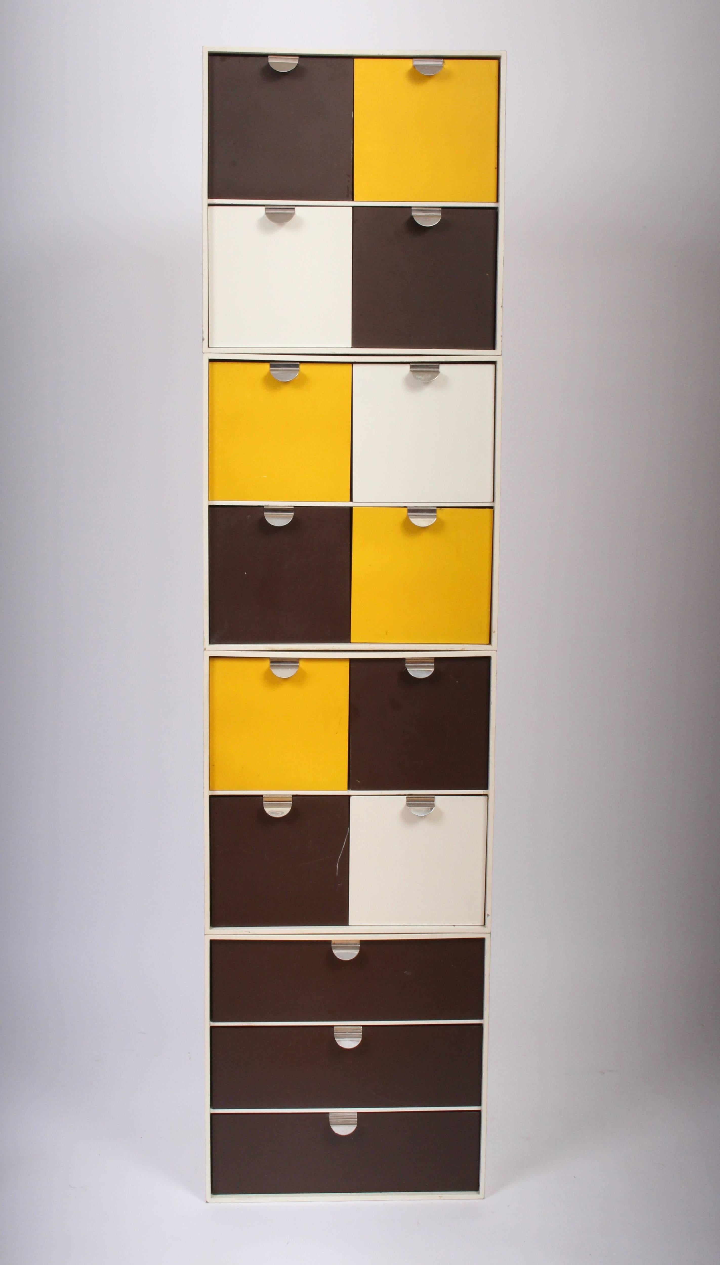 Palaset Treston Oy four modular storage boxes, circa 1970. Featuring White exterior with an assortment of yellow, brown and white drawers. Three cubes with Four Drawers. One unit with Three wide drawers. Ristomatti Ratia designed Made in Finland.