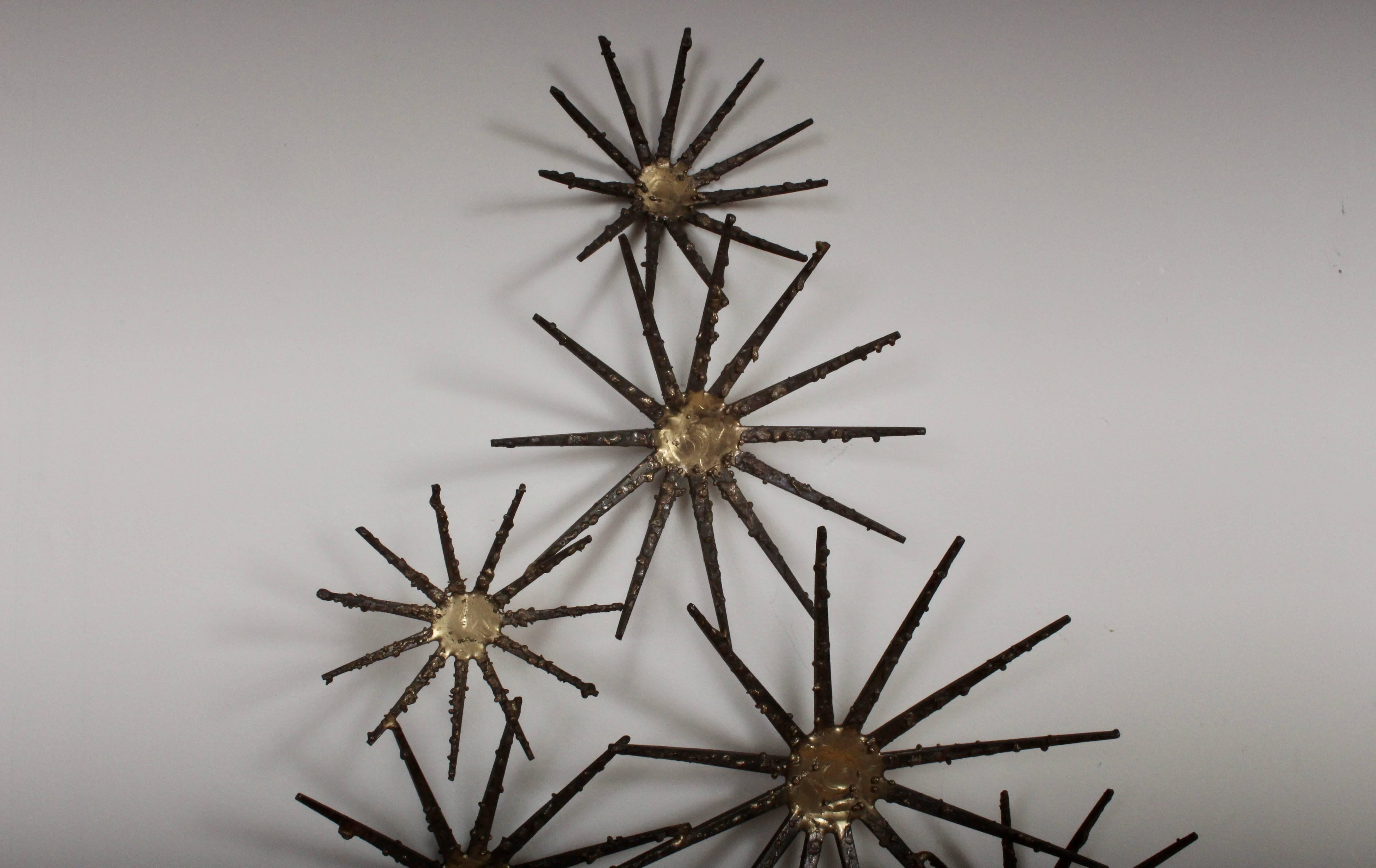 Mid-Century Modern hand constructed Marc Weinstein attributed Starry Night Wall Relief. Featuring 12 handcrafted and connected three-dimensional starbursts utilizing square cut iron nails with welded bright reflective brass centre. Marc Creates