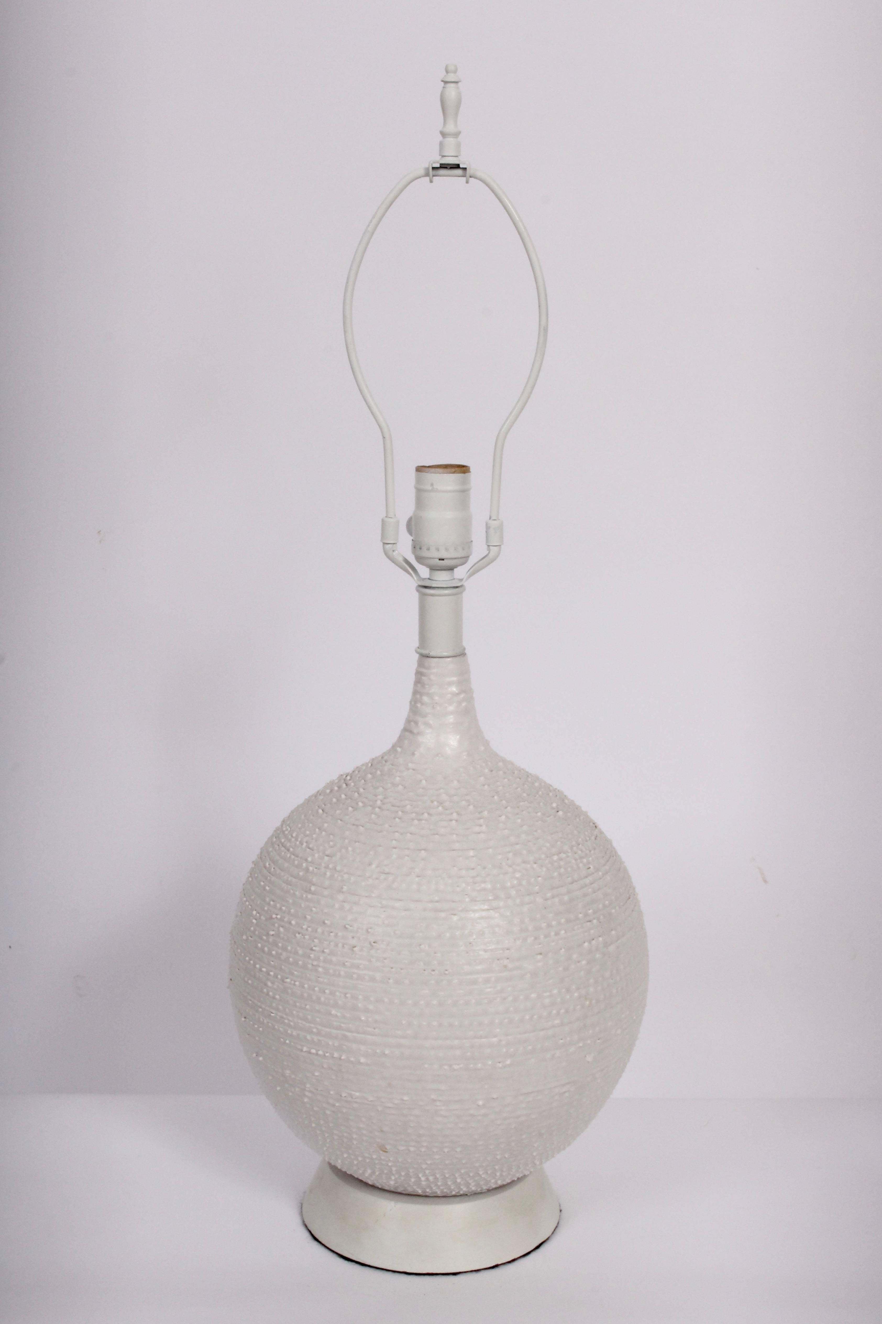 American Mid Century Design-Technics Handcrafted White Pottery Table Lamp. Featuring a substantial textured off white bulbous form with satin glaze. Shade shown for display only and not for sale (9.25H x 12D top x 13D bottom). 19H to top of socket.