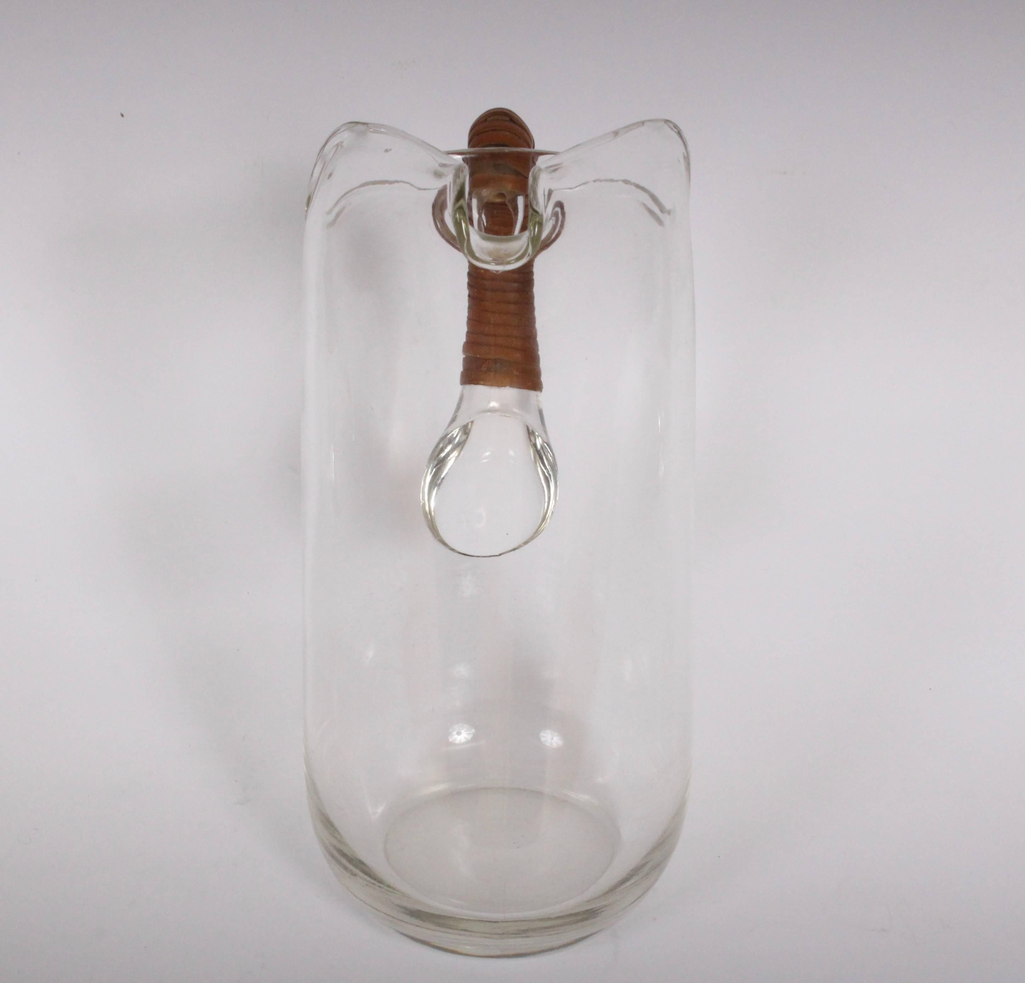 Modern Carl Auböck glass pitcher with caned wrapped handle, circa 1950s.
3