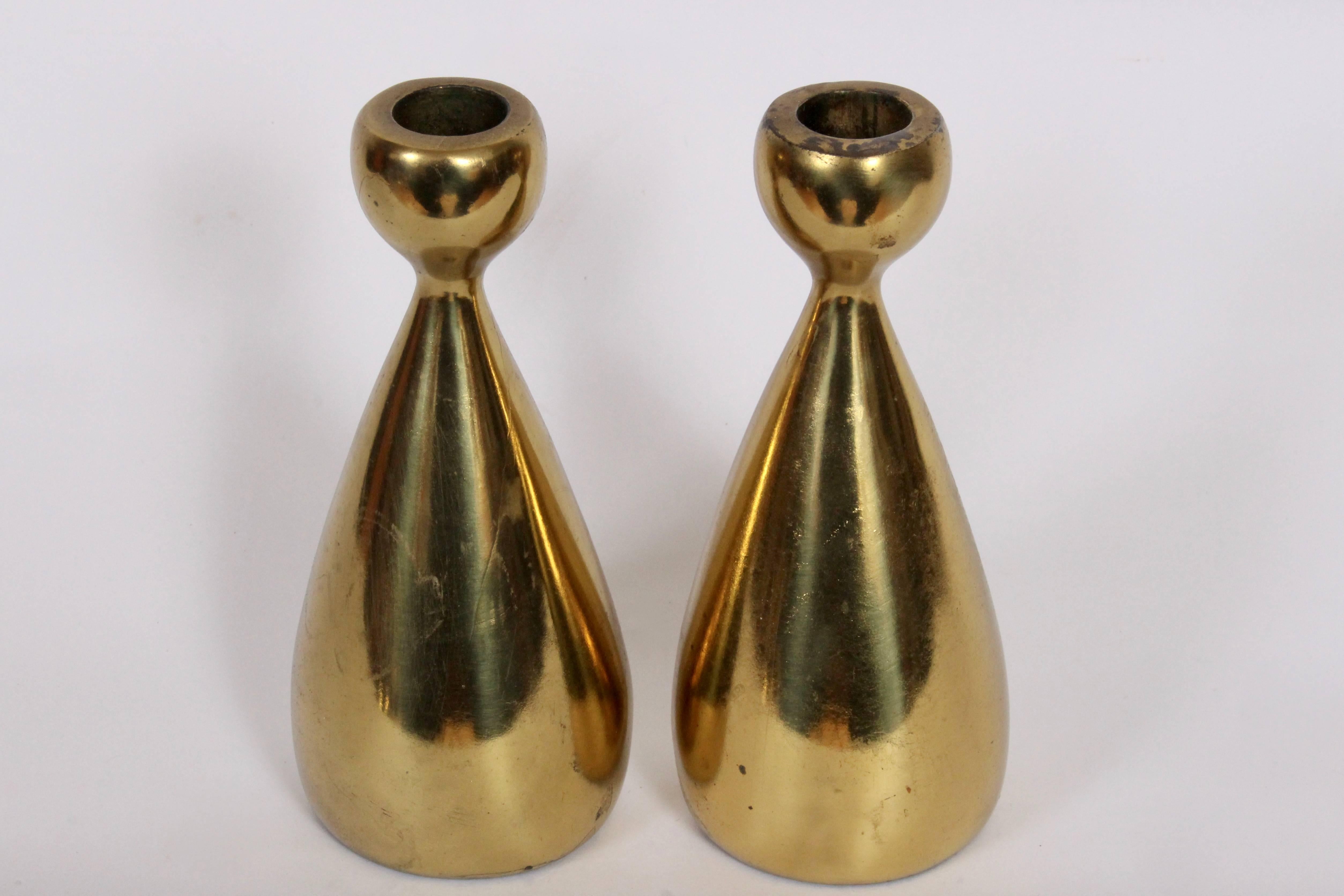 Organic Modern Pair of Brass finished Candlesticks by Ben Seibel for Jenfredware. Utilize taper candles. Sculptural. Reflective. American Mid Century. With label to underside.
