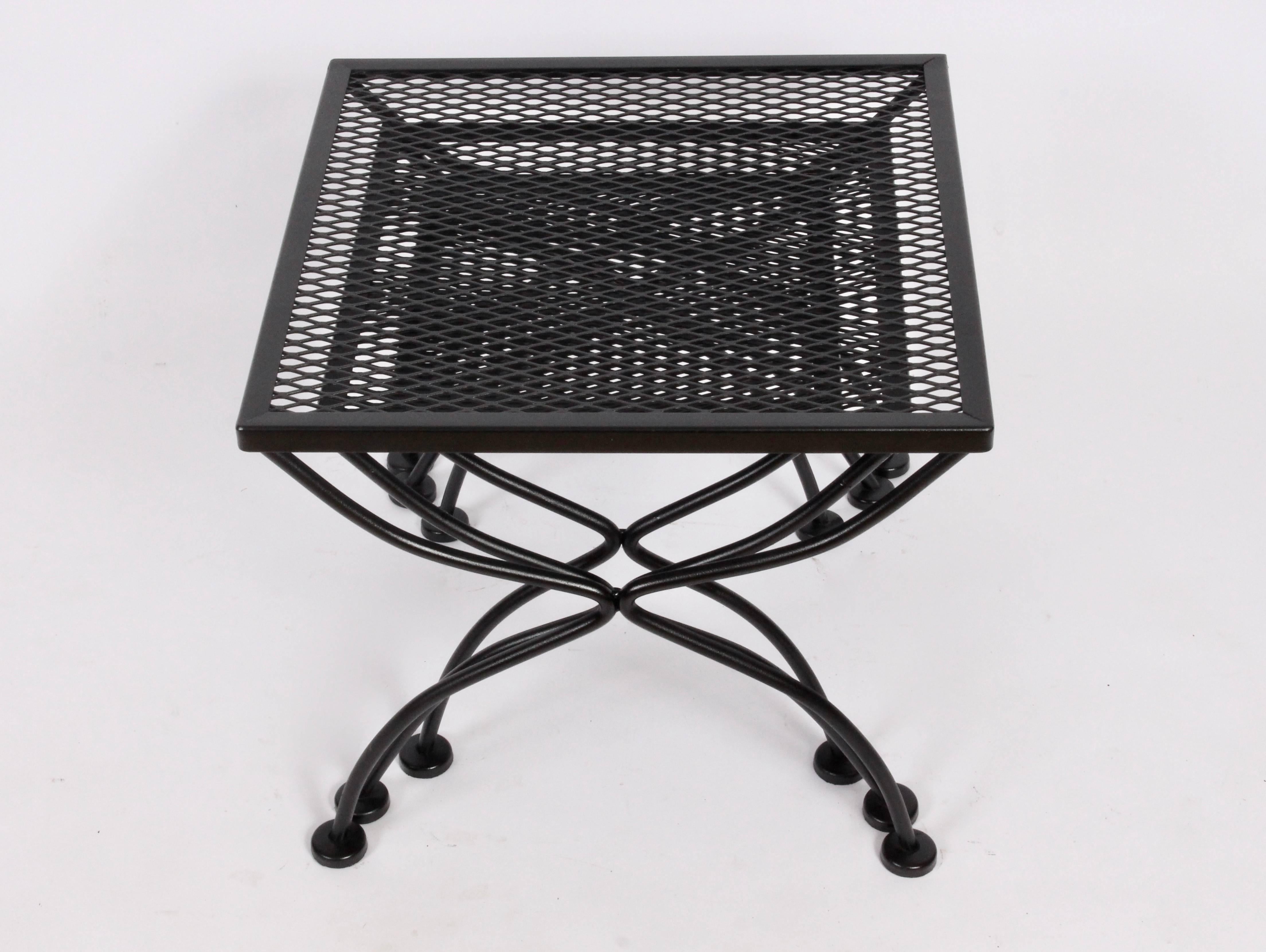 American midcentury black enamel wrought iron nesting tables by Russell Woodard. Rectangular painted wrought iron framework with expanded Mesh surface. Suitable for outdoor use. (Medium table 17 H x 12.5 D x 15 W) (Small table 16 H x 12.5 D x 12.5