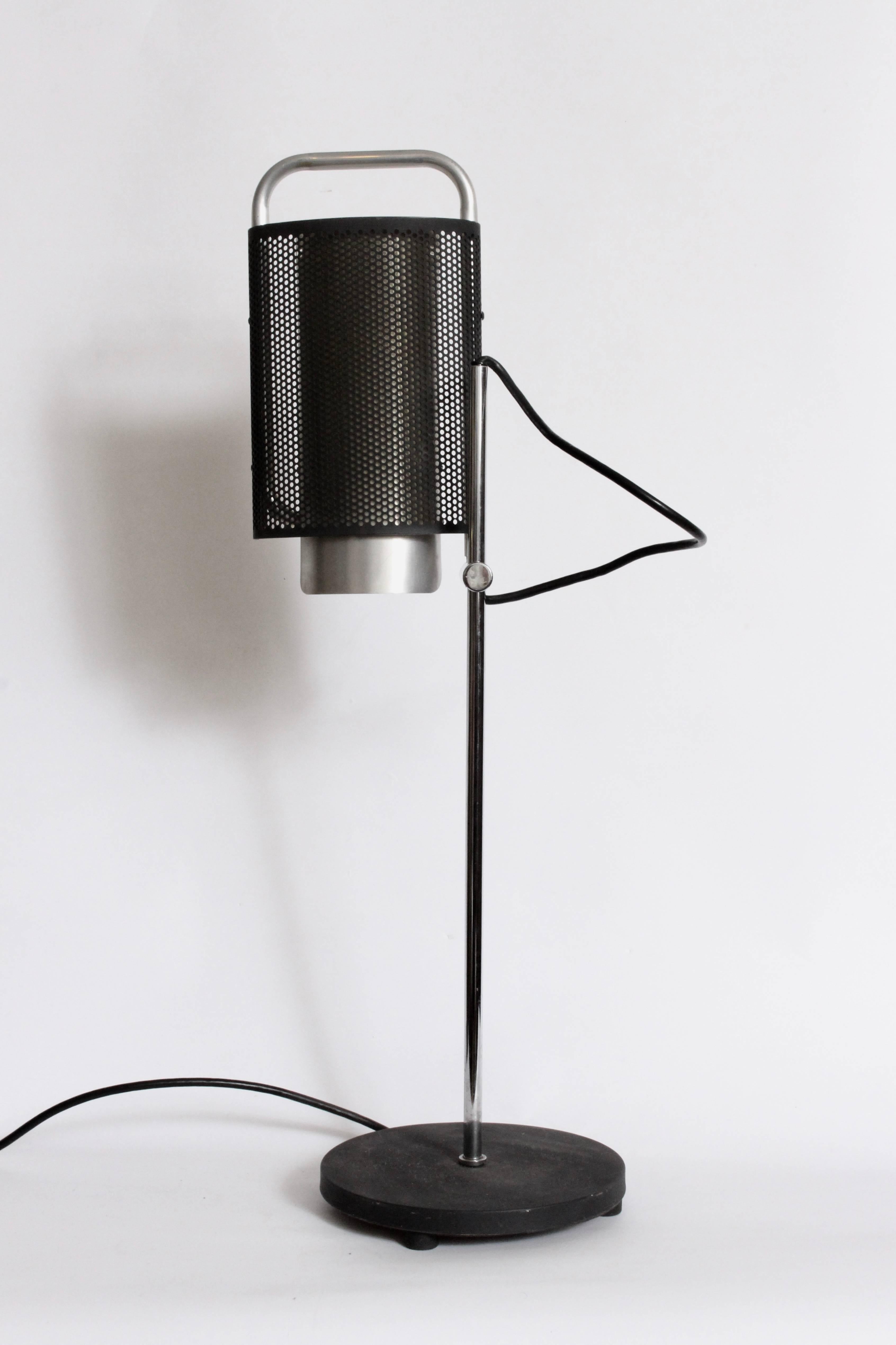 Modern George Nelson for Koch & Lowy Adjustable Perforated Aluminum & Black Enamel Table Lamp. Featuring a perforated Black enameled Aluminum cylinder mesh shade, Off White interior, articulating Chrome arm with round Black Iron base. Shade tilts