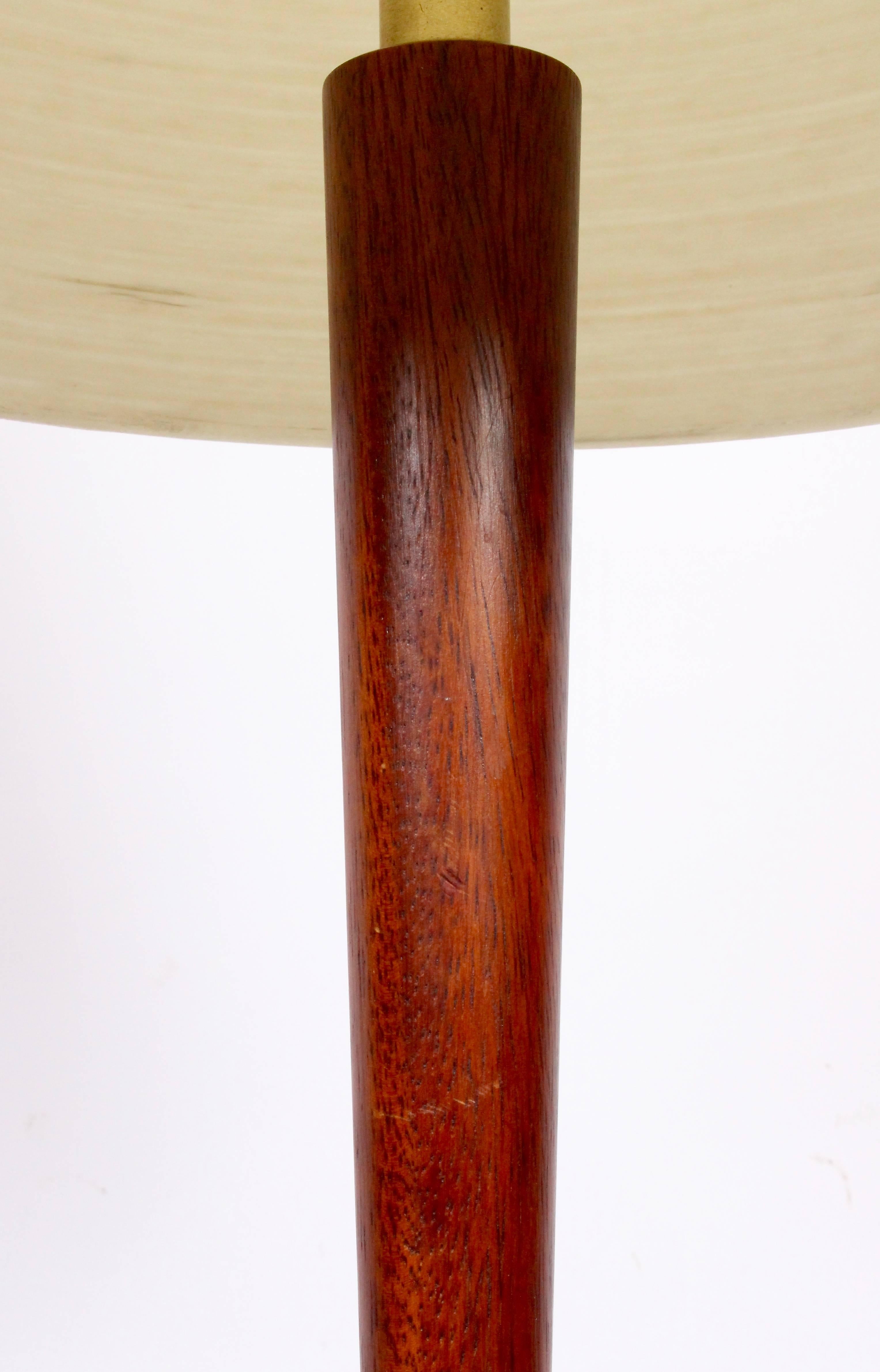 Phillip Lloyd Powell style solid walnut reading floor lamp. 1960's. 49 H to socket. Slender. Small footprint. Shade for display only (12 H x 10 D top x 16.5 D bottom). Rewired with new brass hardware and black braided cloth cord. Refinished. 