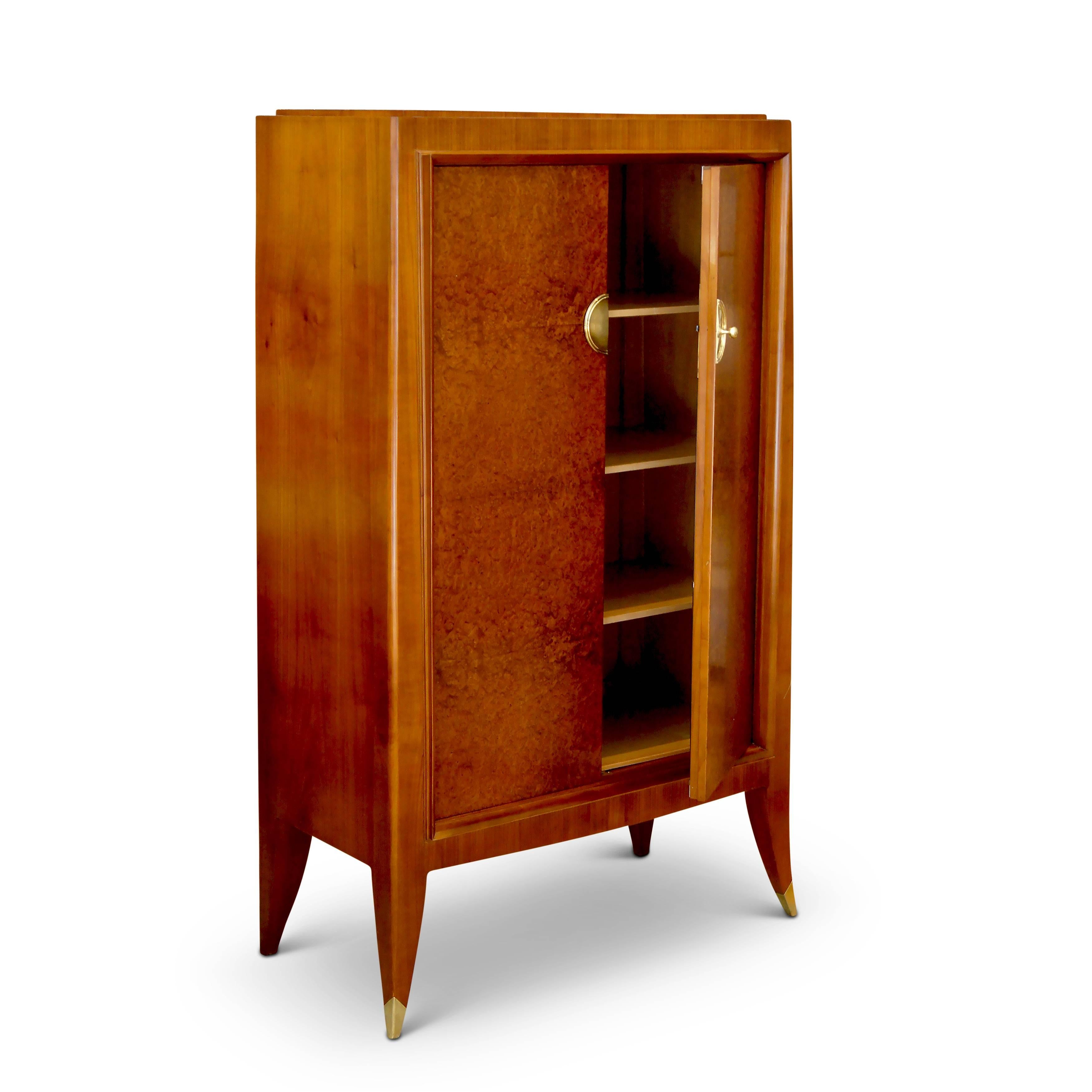 Fine cabinet (forming an original custom set with a storage cabinet, also available) by Alfred Porteneuve (1869-1949). The sculptural case-piece is superlatively crafted in fruitwood (likely cherry) with amboyna (burl walnut) veneer on the doors. A
