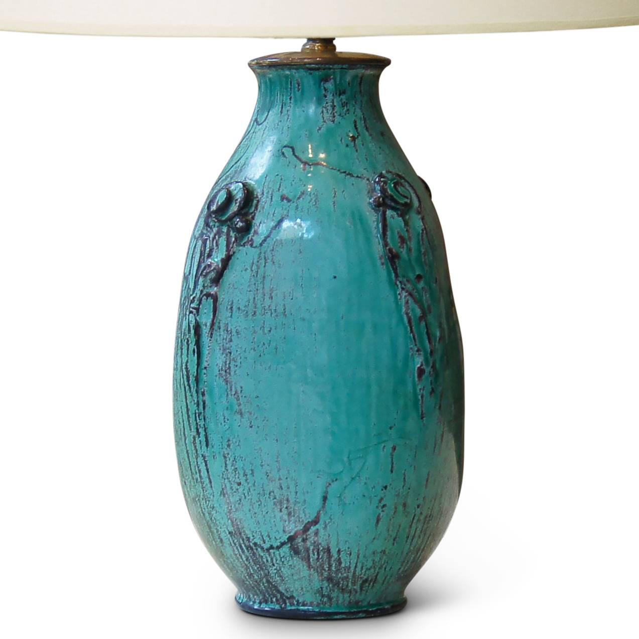 Table lamp by Svend Hammershøi for Kähler, having vase form with four frond motifs emerging at shoulder and carved vertical texturing, hand modeled in earthenware with a teal (veering blue) and gray glaze developed by Jens Thirslund, Denmark,