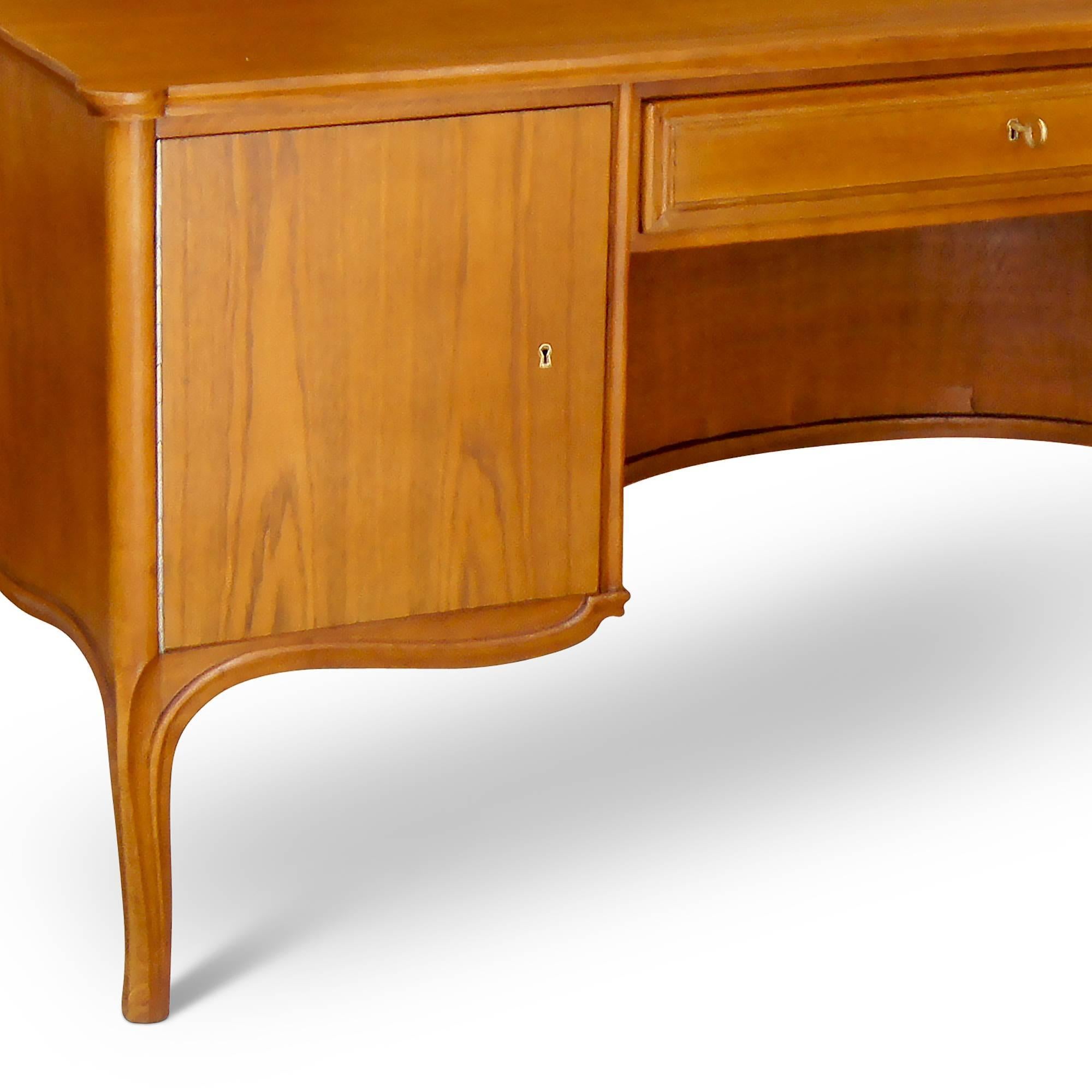 Equally elegant and practical, this rare kneehole desk design by Frits Henningsen (1889-1965) is a wonderful example of this 20th century Danish master's talent for adapting historical furniture types for modern living. A functional workhorse, this