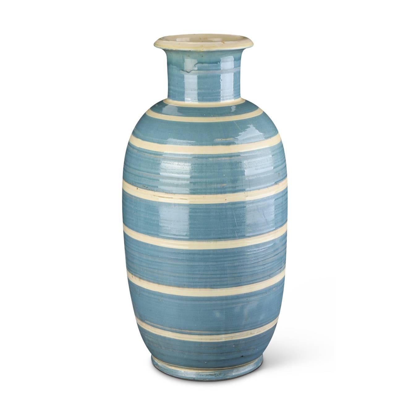 Monumental vase with elongated oval form and neck with flared mouth in hand-turned earthenware, handsomely glazed in grey-blue with ivory stripes, Denmark, 1930s. Painted “HAK” mark.

