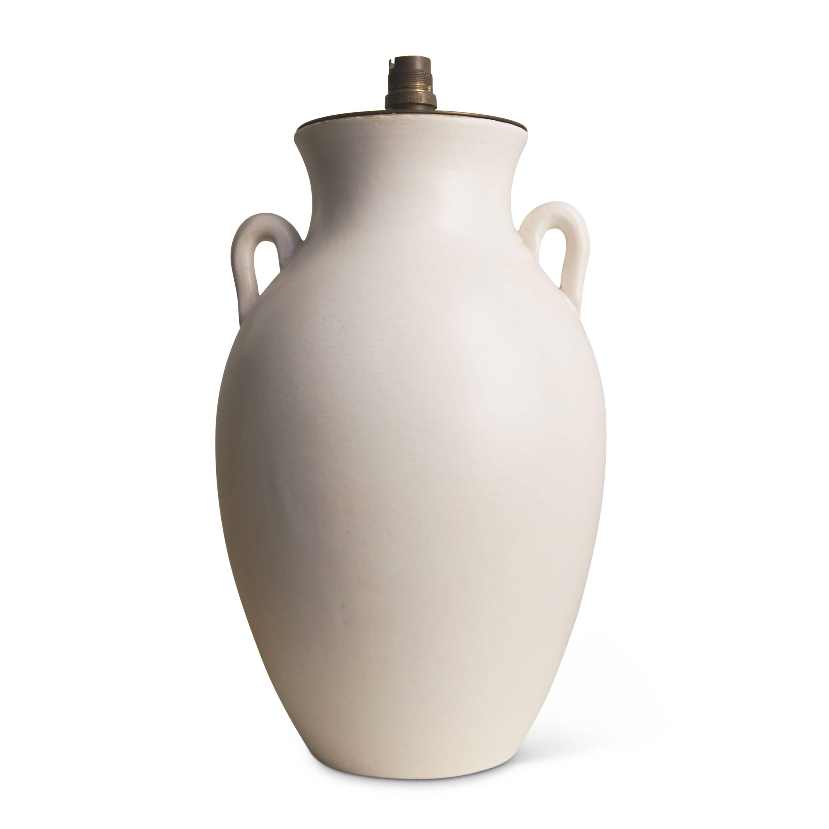 Elegant Mid-Century adaptation of a Classical Amphora form, perfectly proportioned and modeled in a lovely eggshell finish ivory glaze, this lamp by French pottery house Keramos is exquisite in every detail, and radiates the sculptural and dreamy