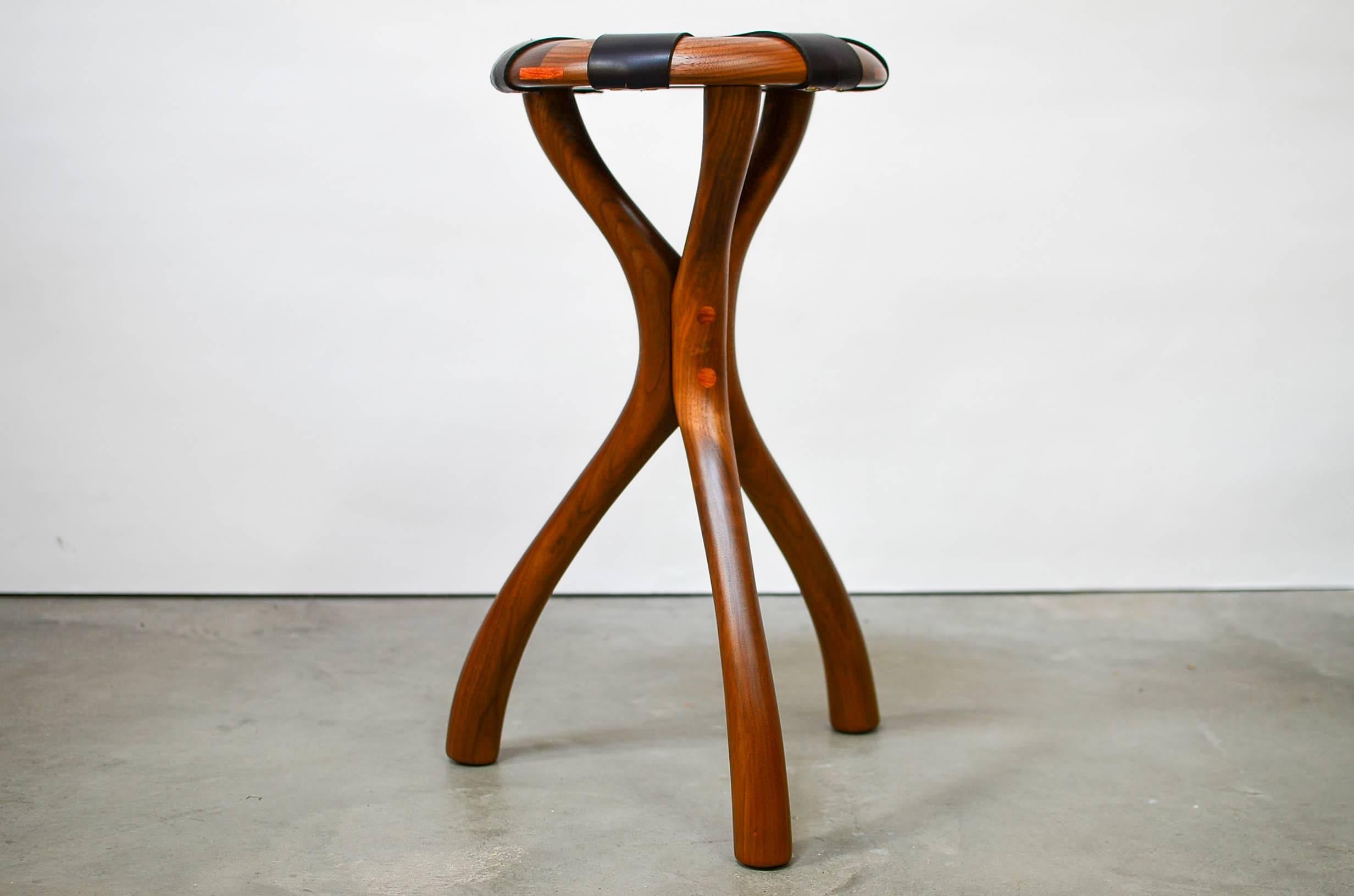 Stunning black walnut and leather strapped stool with bubinga details designed by Master Craftsman, Dean Santner. 

Dean originally designed this stool in 1969, but only one was made.

Up to 12 stools are available for custom order. Other