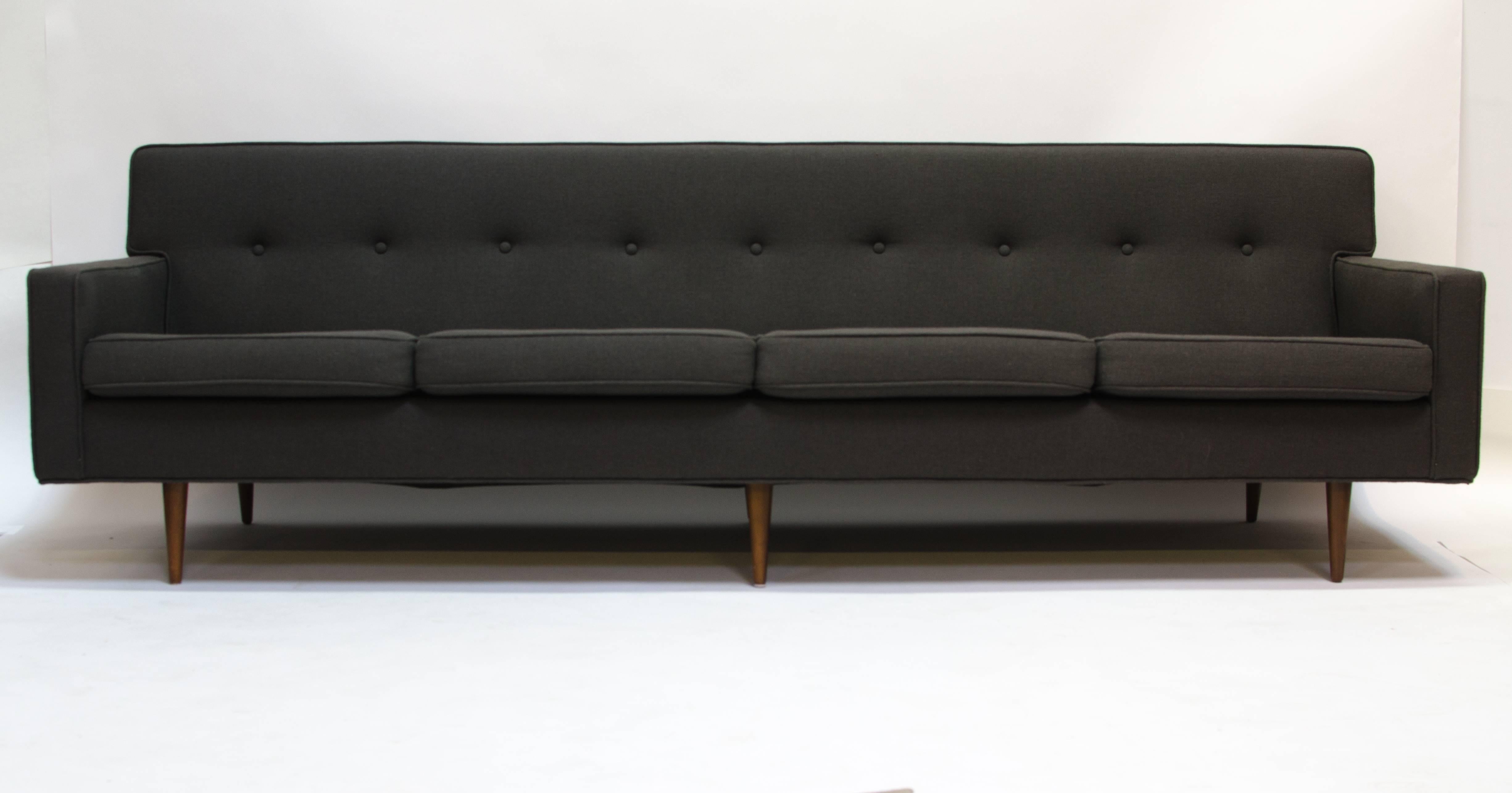 Stunning Mid-Century Modern sofa possibly designed by Paul McCobb. Freshly recovered in charcoal grey Maharam fabric.