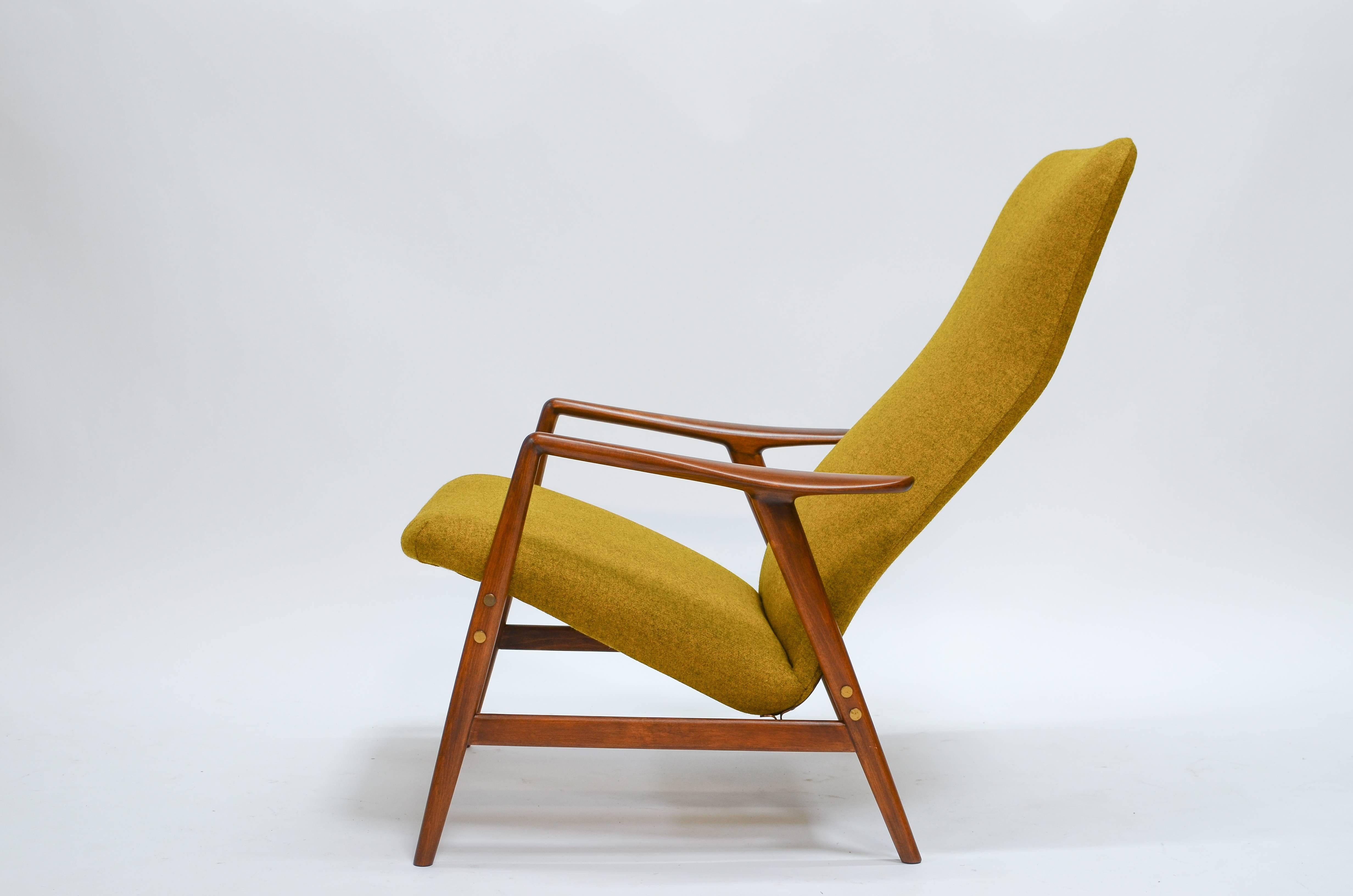 Danish modern highback reclining lounge chair designed by Alf Svensson for Fritz Hansen in 1957. The frame features sculpted teak arms and spindle legs. The back of this chair can be reclined and locked into place for hours of comfortable sitting.