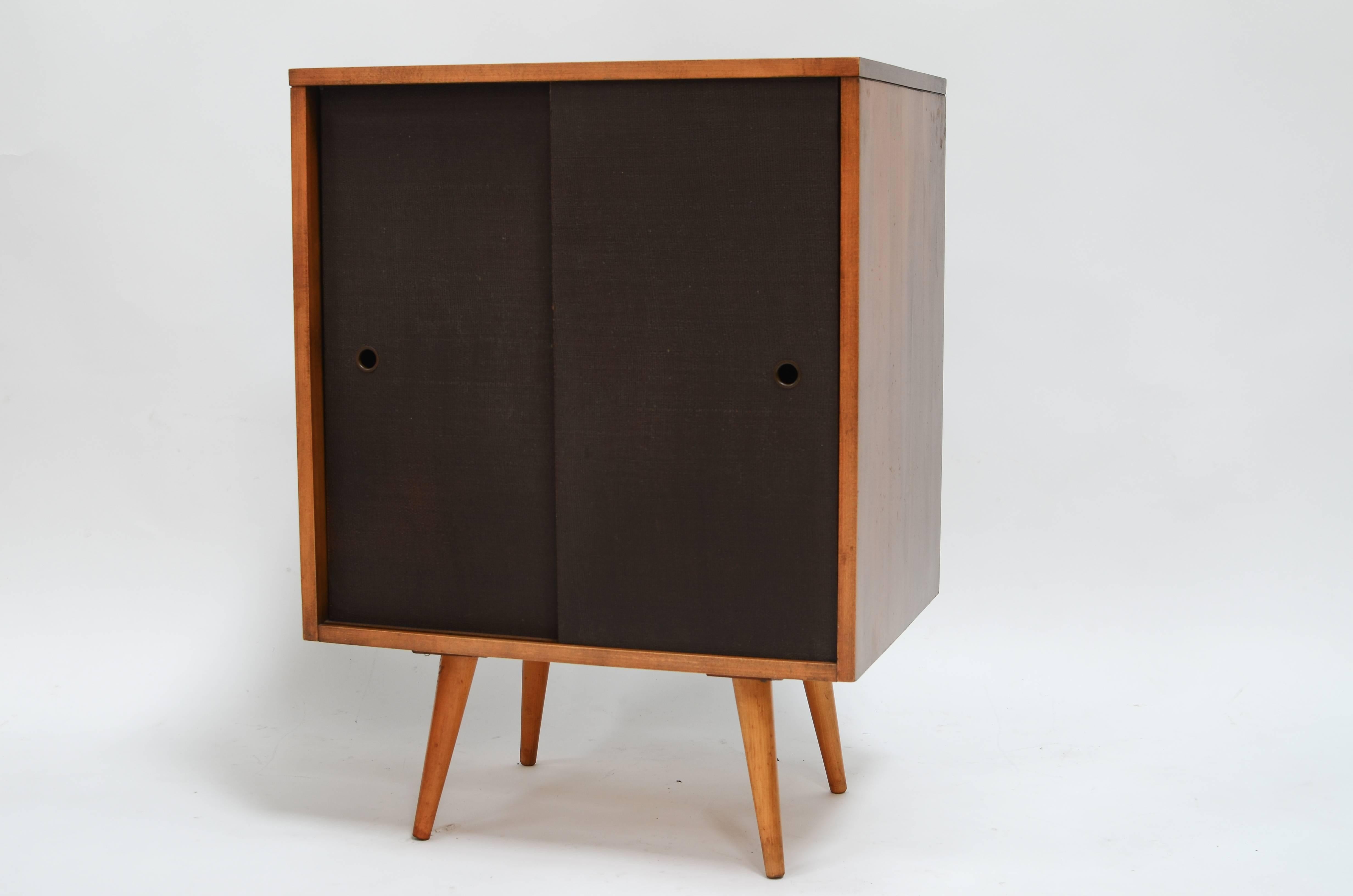 Stunning small grasscloth cabinet designed by Paul McCobb for the Planner Group, c1950s. All original condition with no damage. Signed with original designers label. 

McCobb's Planner Group, manufactured by Winchendon Furniture Company, was among