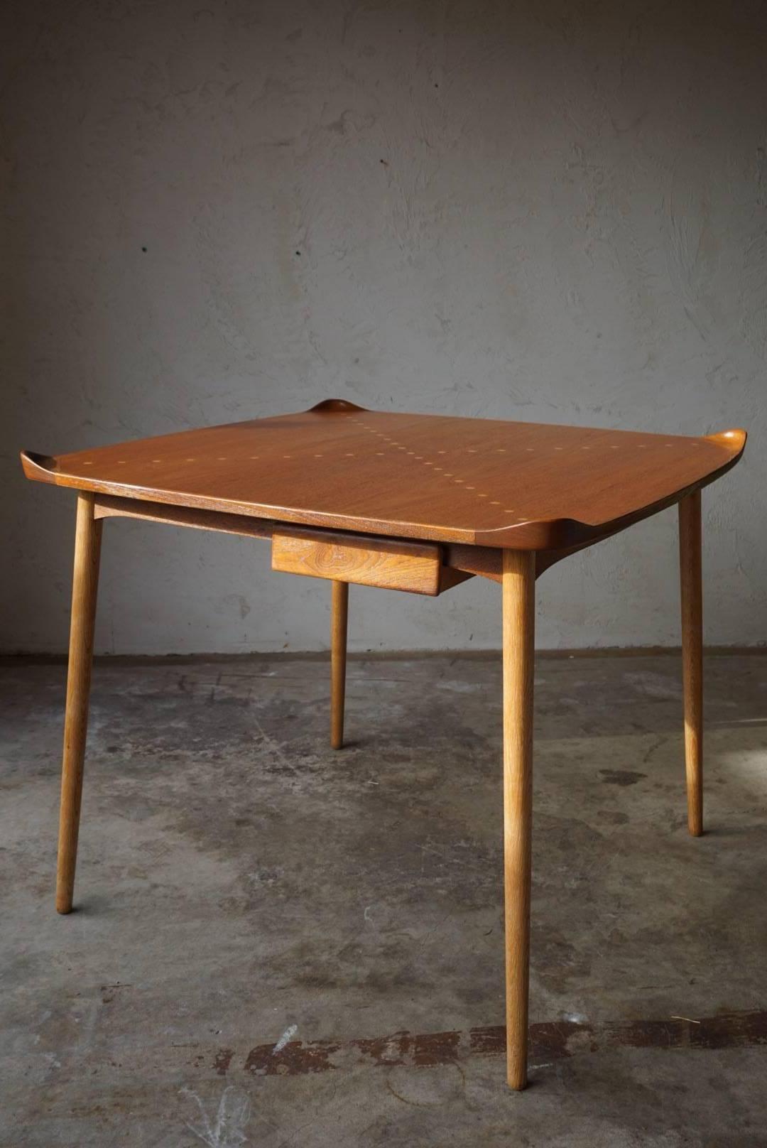 Rarely seen model FJ55 game table designed by Finn Juhl for Niels Vodder, circa 1948. Stunning inlay and detail work with Juhl's signature flared edges make for an exceptional piece sure to complement any space. The attention to detail on this piece