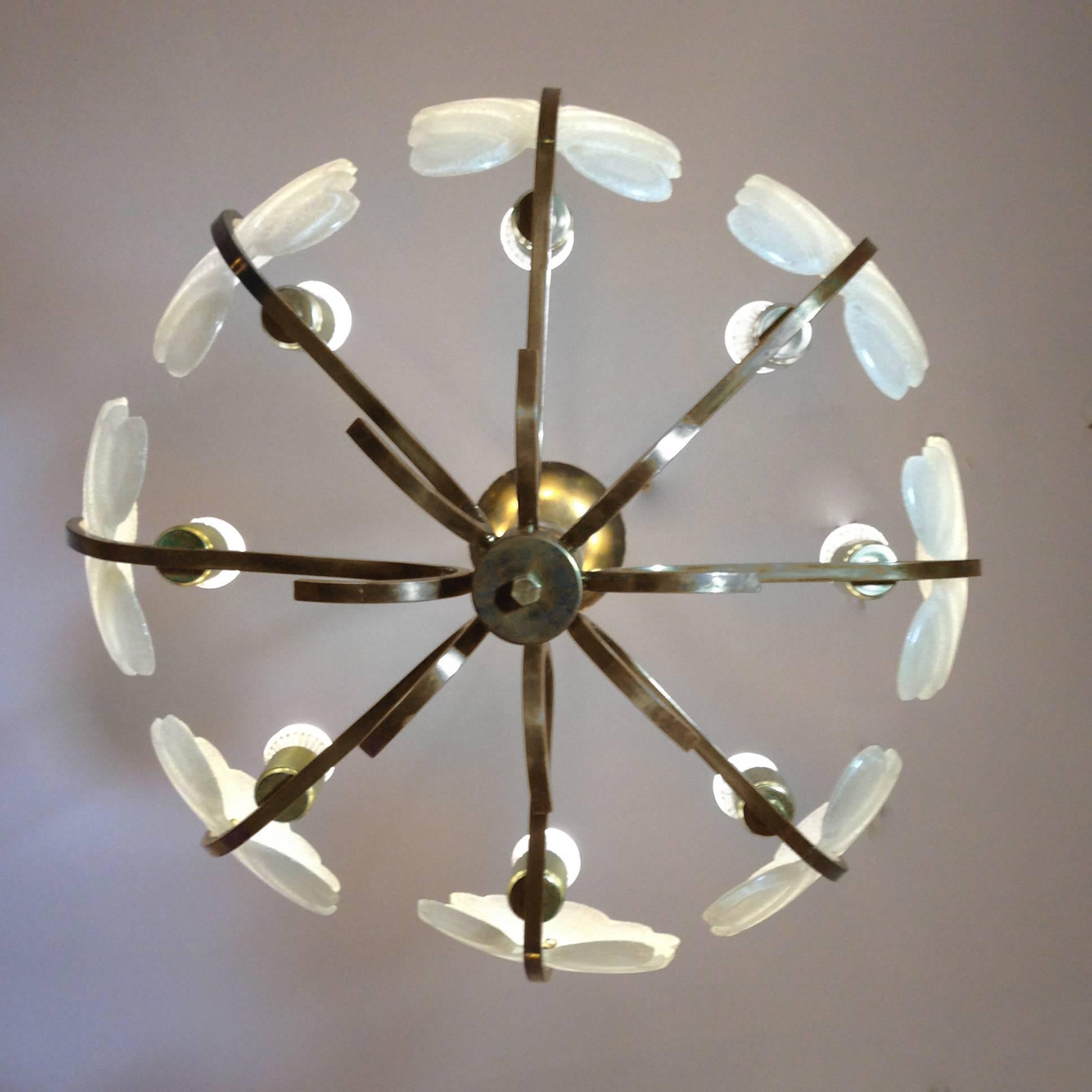 Large chandelier by Carl Fagerlund for Orrefors. Eight leaves made of frosted glass with eight bronze arms.