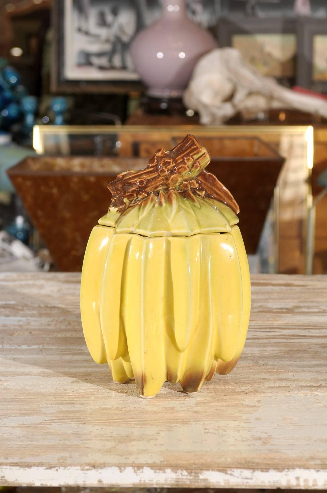 American mid-20th century yellow and brown ceramic container with removable lid in the shape of a bunch of bananas. Made by McCoy Pottery.