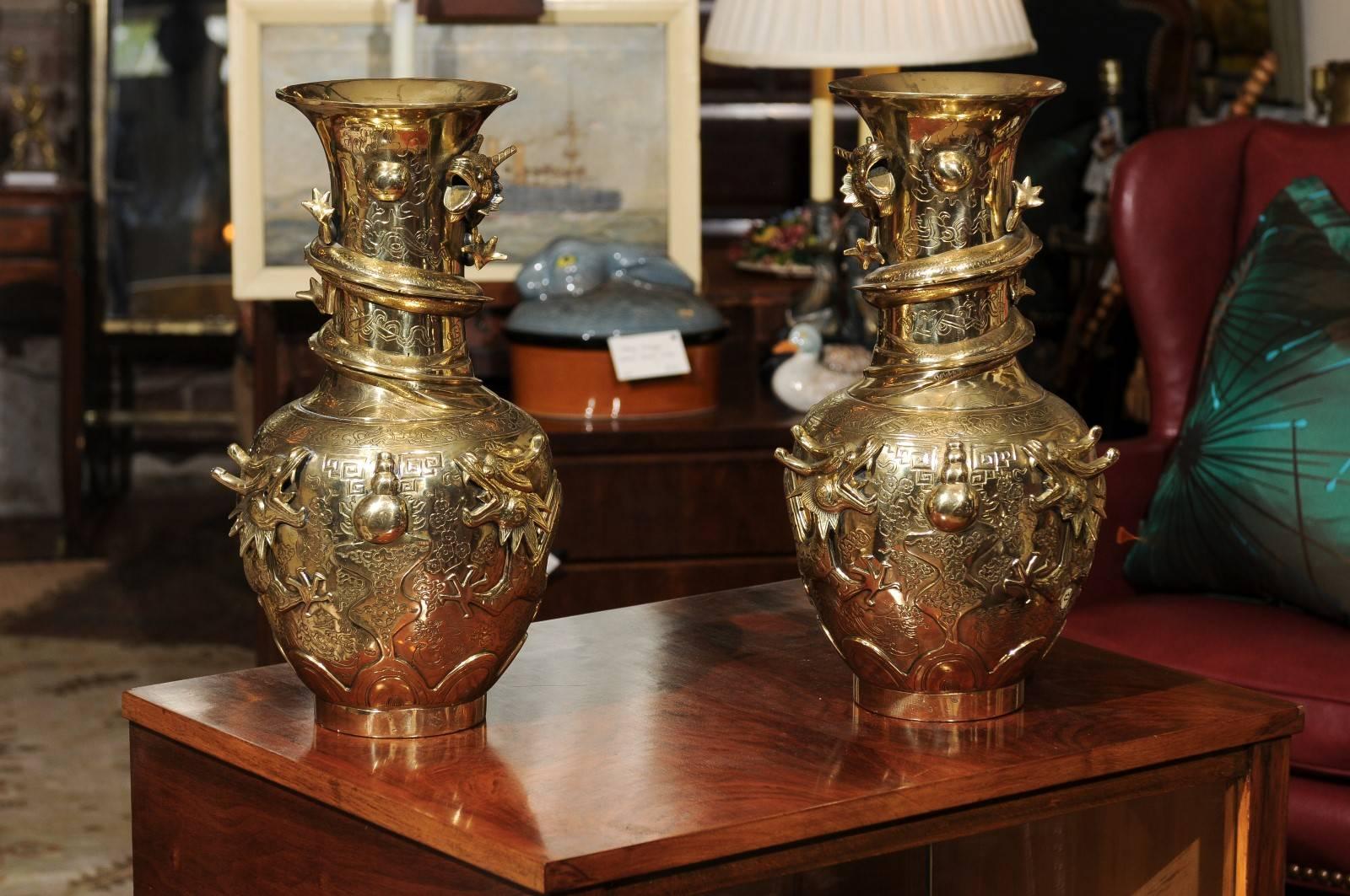 19th century exceptional pair of bronze Chinese Qing dynasty vases with detailed dragon motifs. Marked on the underside.