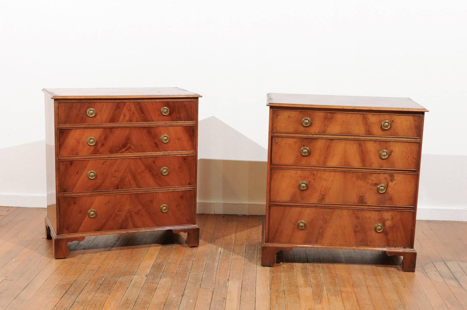 Early 20th century pair of English bachelor chests in the Georgian style and made of flame mahogany veneers. The four graduated drawers have brass ring pulls and back plates. The chests were made in Ipswich, England in the 1920s by Frederick
