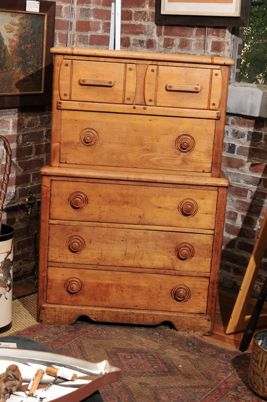 19th century English secretaire of solid pine with two upper drawers over a fitted slide out fall front desk. The case holds three more drawers below. When open, the secretaire measures 30.5