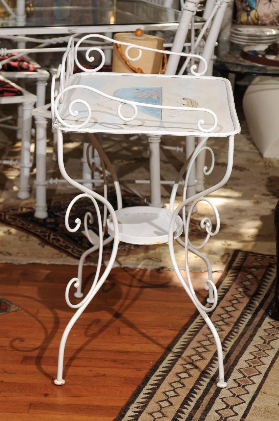 Late 19th Century French wrought iron garden table painted in white with a charming Victorian era steampunk illustration of a whale shaped hot air balloon carrying three sailors in a suspended boat.  