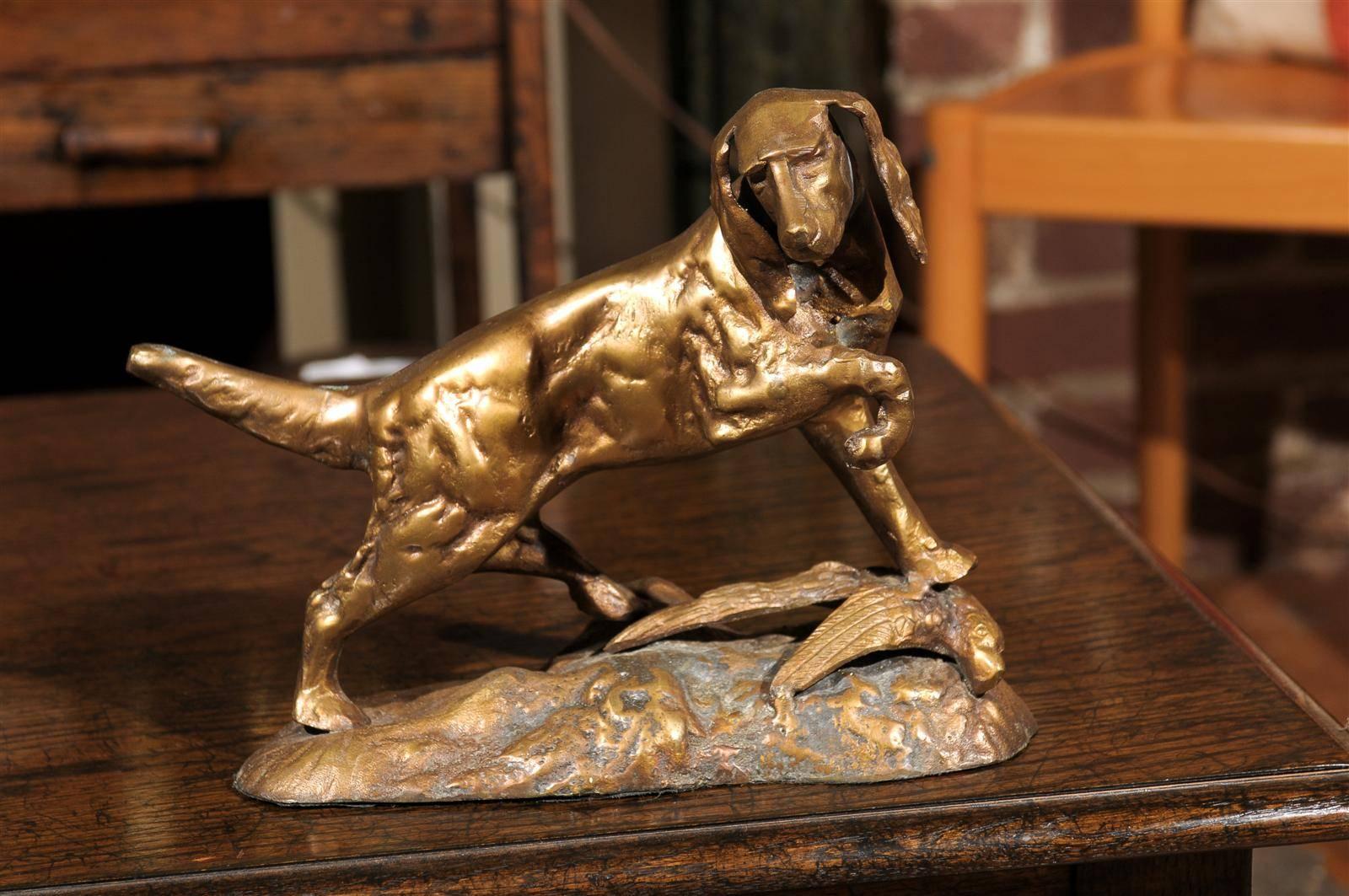 20th century bronze baroque statue of a hunting dog with bird.  