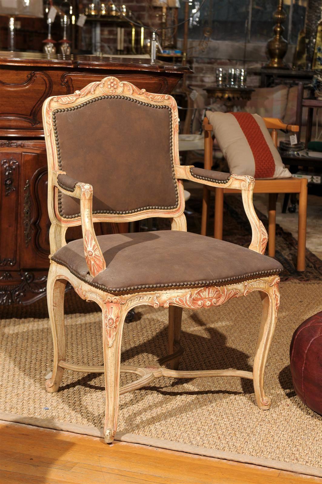 20th Century hand carved and painted wooden fauteuil or side chair in the Louis XV style with the seat, back, and arms upholstered in chocolate brown suede and decorated with nailheads.
