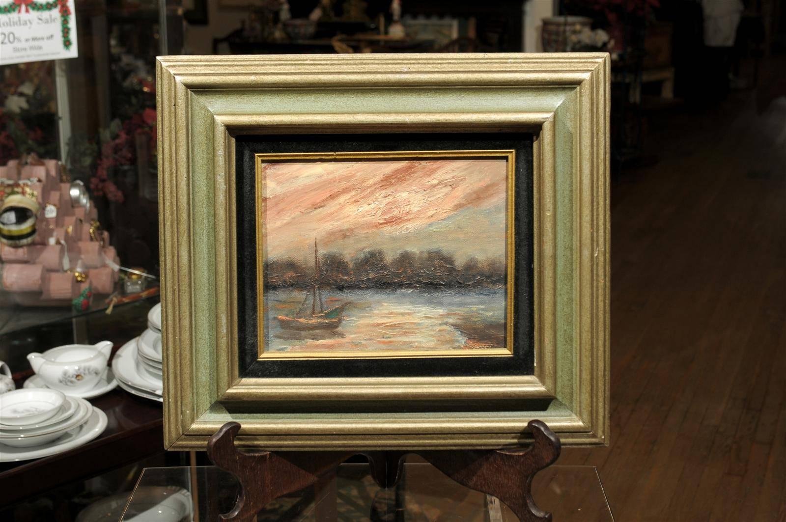20th Century impressionistic oil on canvas of a sailboat on a lake at sunset, having a black velvet and gilt lining, and in a green and gold painted frame.  Unsigned.  