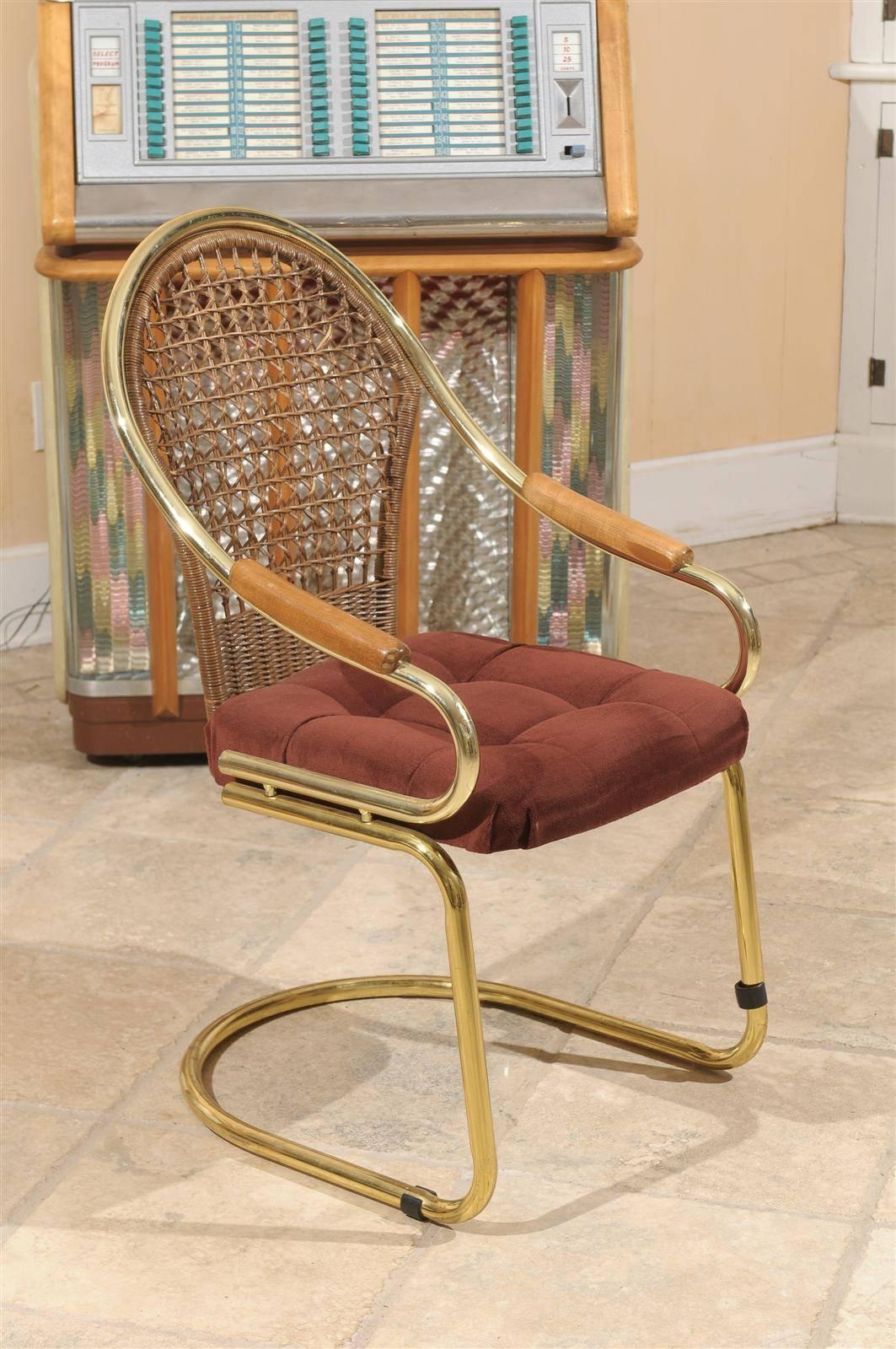 Mid-Century cantilevered desk or side chair of brass with a cane back, wooden armrests and a tufted upholstered seat. The chair comes with rubber removable floor guards.