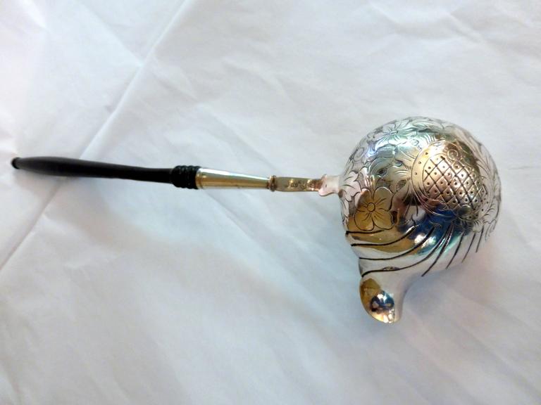 Continental silver (.800) soup or punch ladle, with turned wood handle, circa 1860s. Bowl of ladle is etched and is gilded. Measures: Almost 14 1/2 inches long x 4 inches deep (at deepest point) x a little over 2 1/4 inch sq high (at highest point).