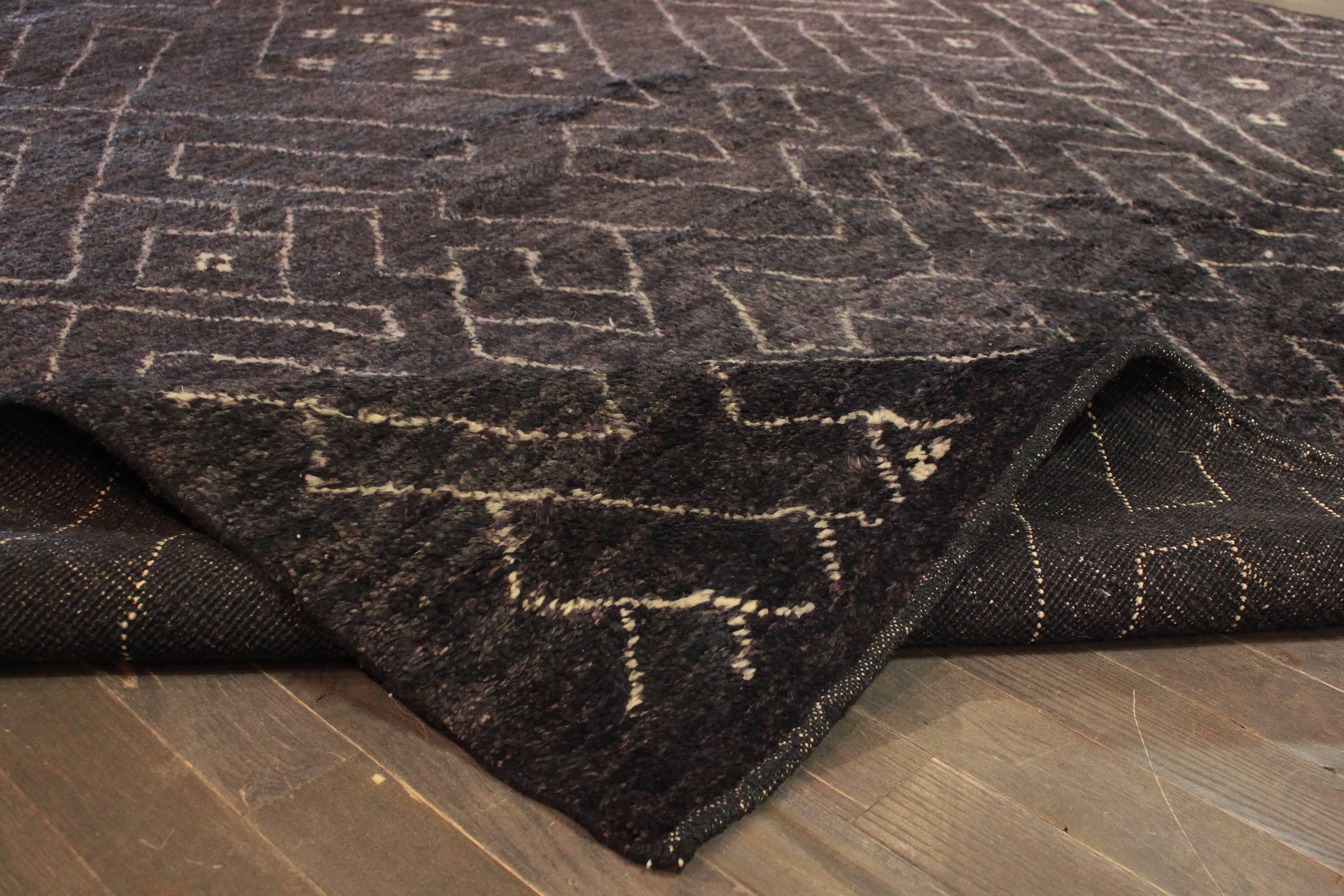 Hand-made Moroccan Berber with an all-over geometric design on a black field. Measure:9'2