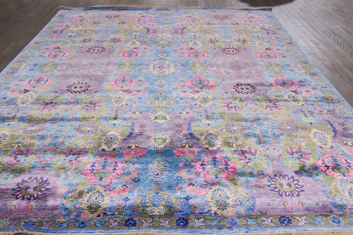 Modern (2016) Indian rug with a blue field and multicolored pattern throughout. Measures approximateky 9 feet by 12 feet.