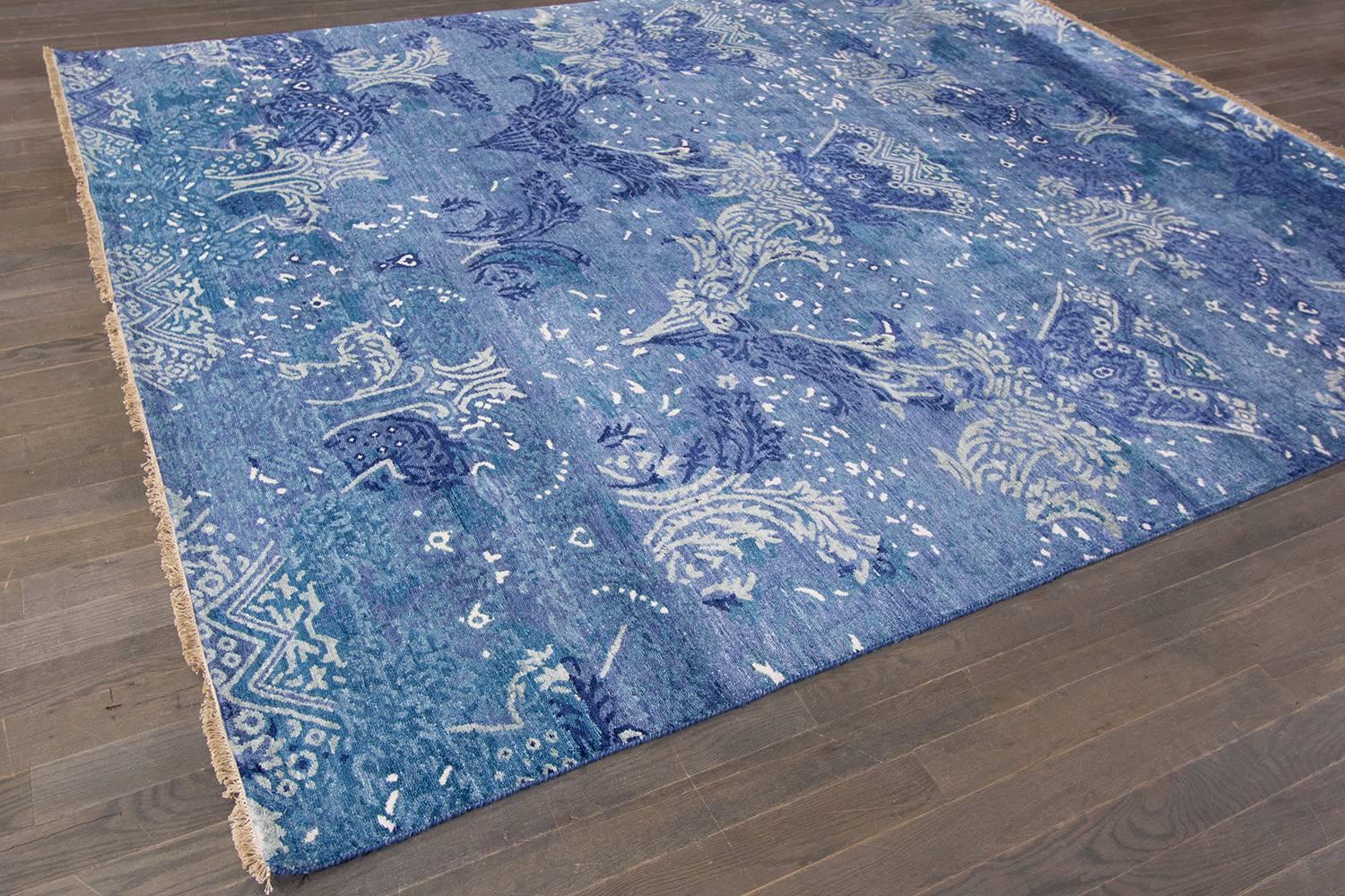 Hand-knotted Indian rug with an all-over design on a blue field.