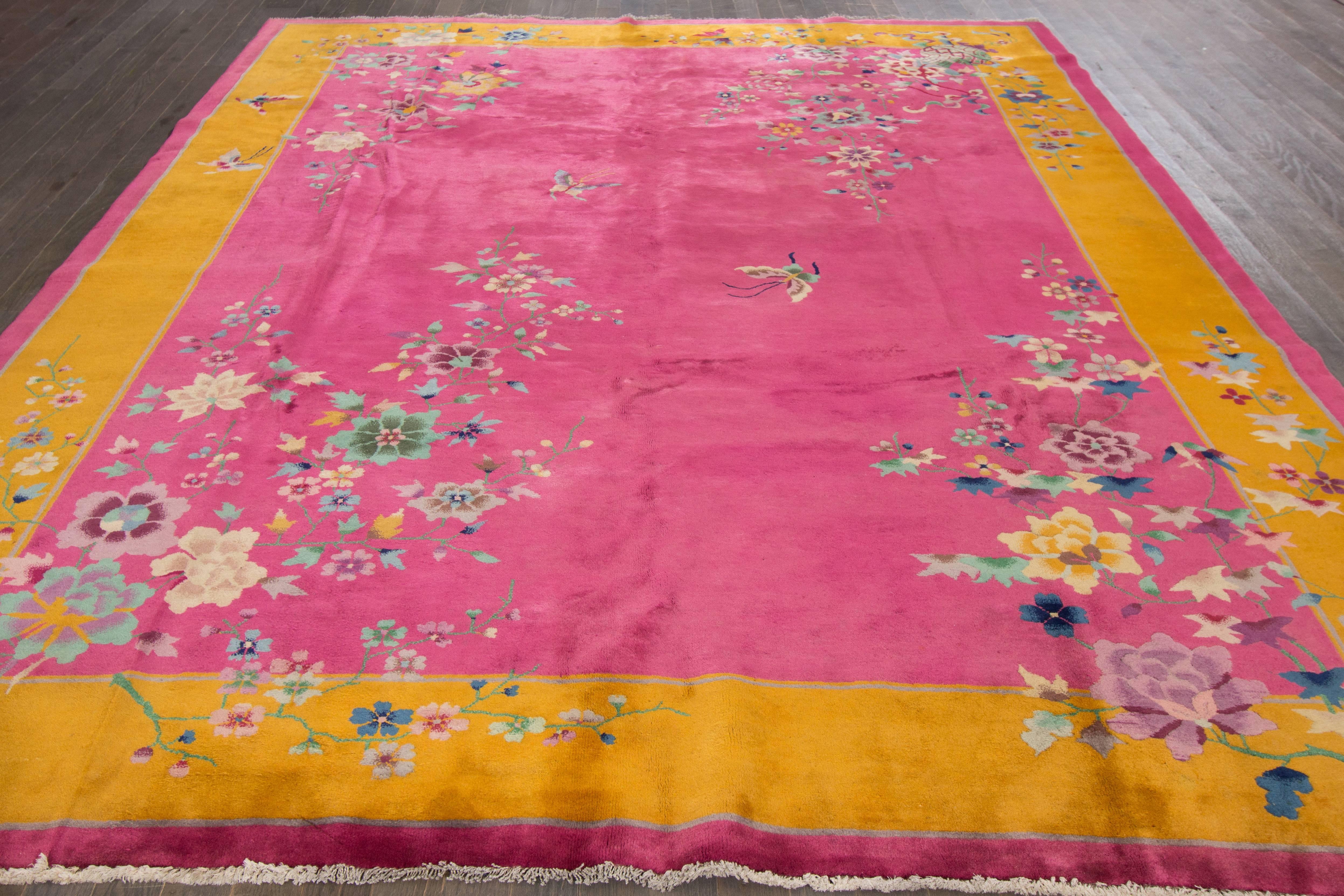 Antique hand-knotted Chinese deco rug with a floral design on a pink field and yellow borders.
Size: 9' x 11'6