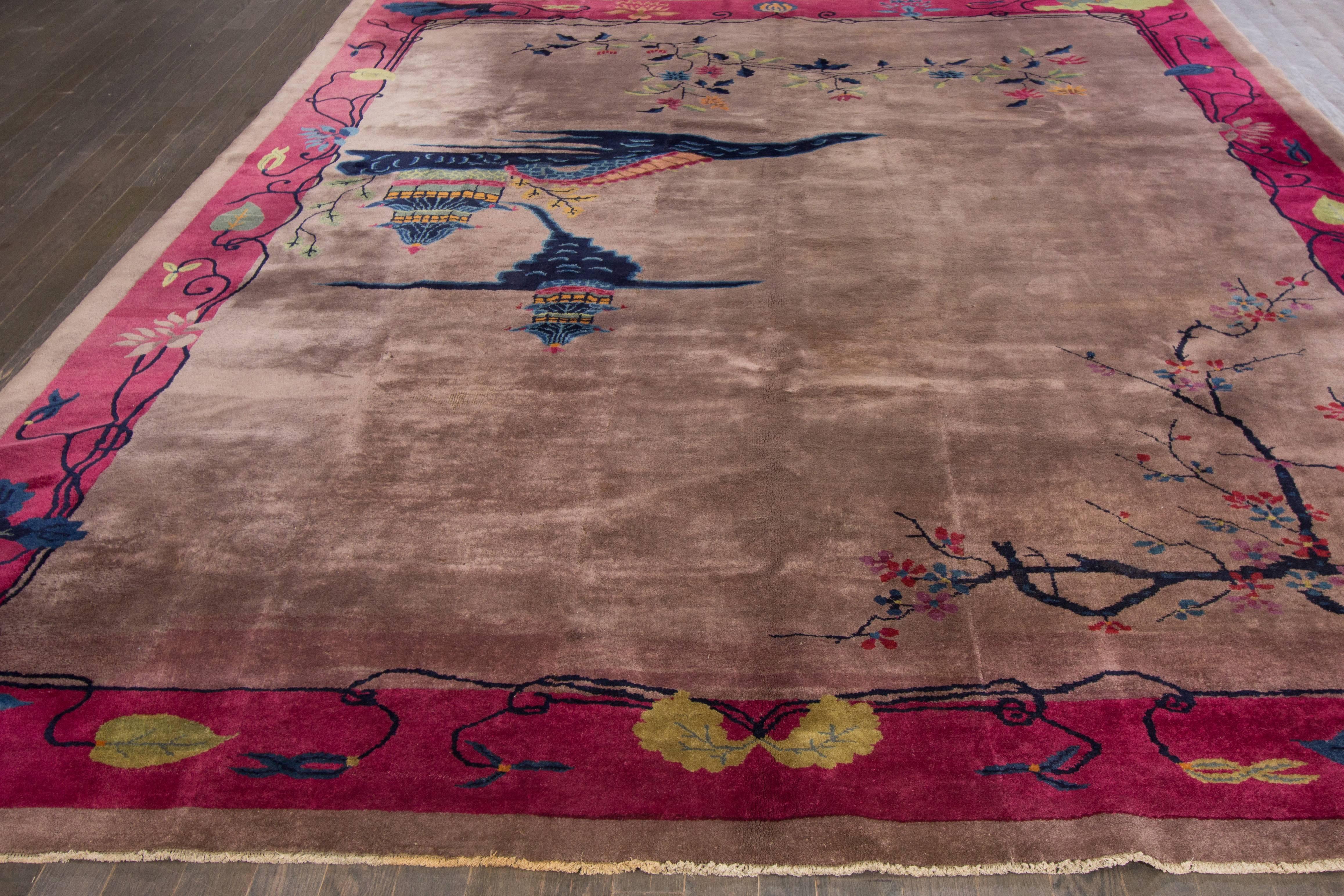 Vintage 1920s Chinese Art Deco rug with a wide purple border and rose field with a traditional, multi-colored design. Measures 9x11.06.