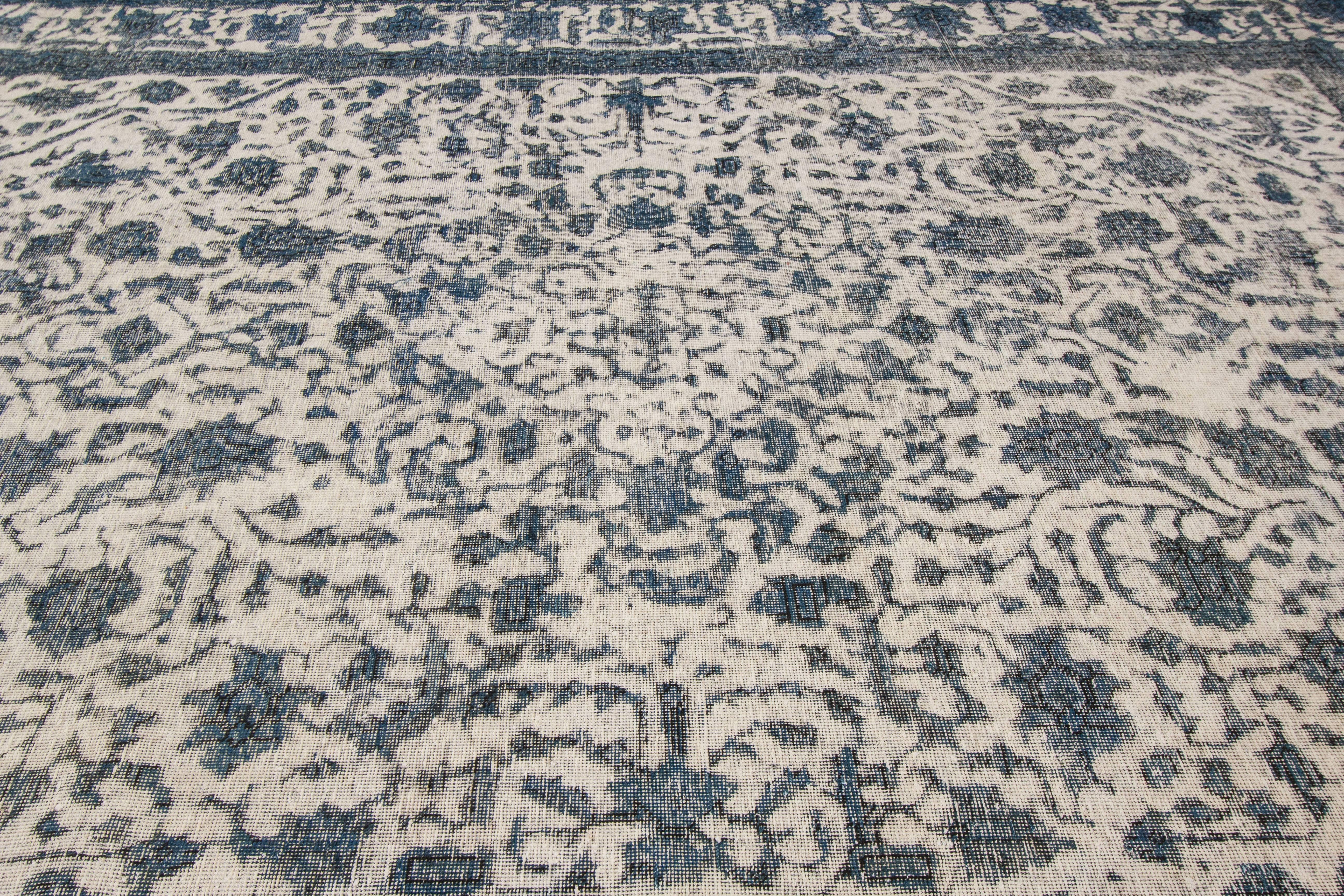21st century contemporary (2000) Pakistani rug with an ivory field and teal/blue overdyed all-over design. Measures 9.09x12.08.