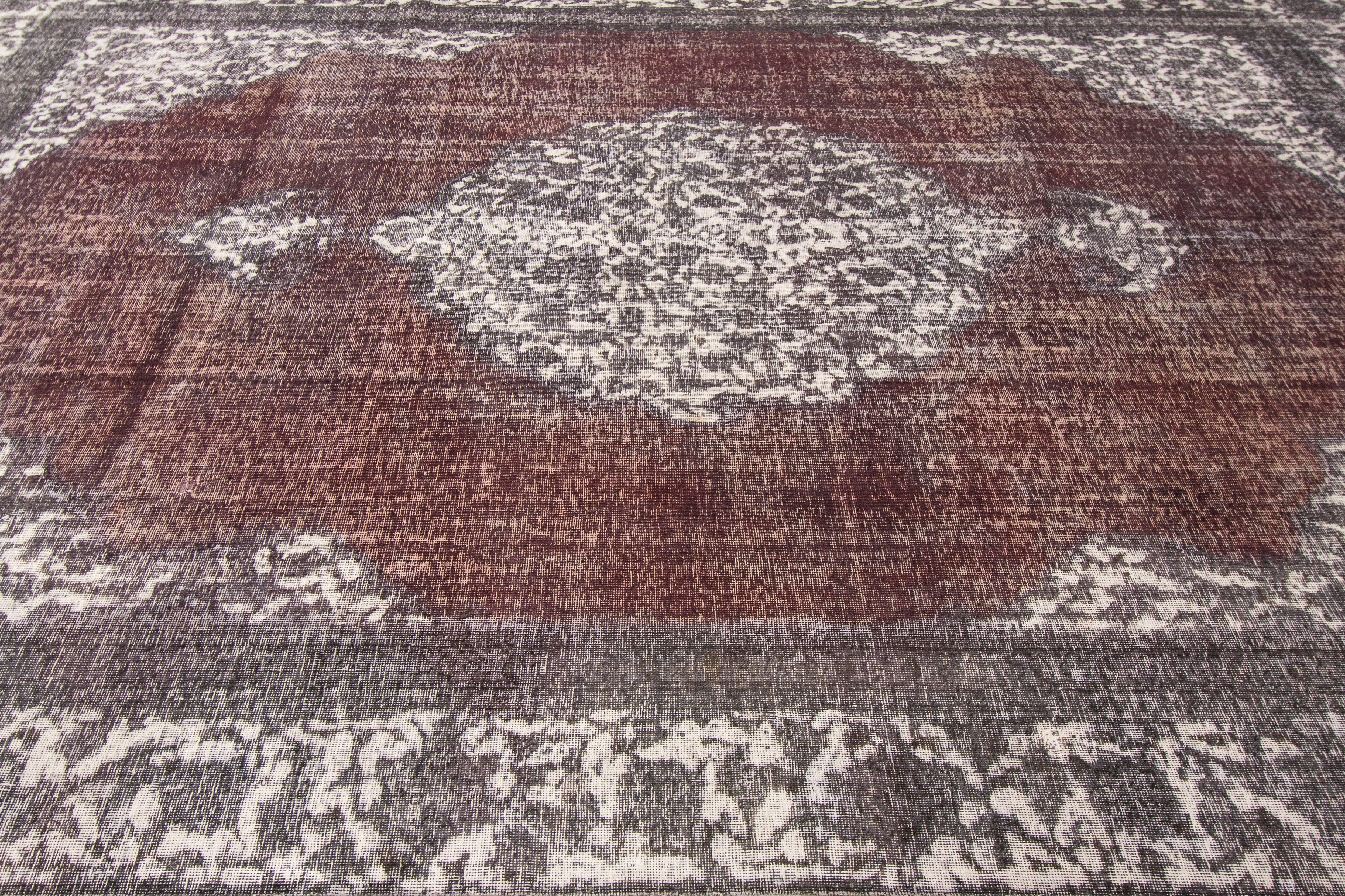 21st century contemporary (2000) Pakistani rug with an overdyed red and gray field and traditional medallion design. Measures 9.09x12.08.
