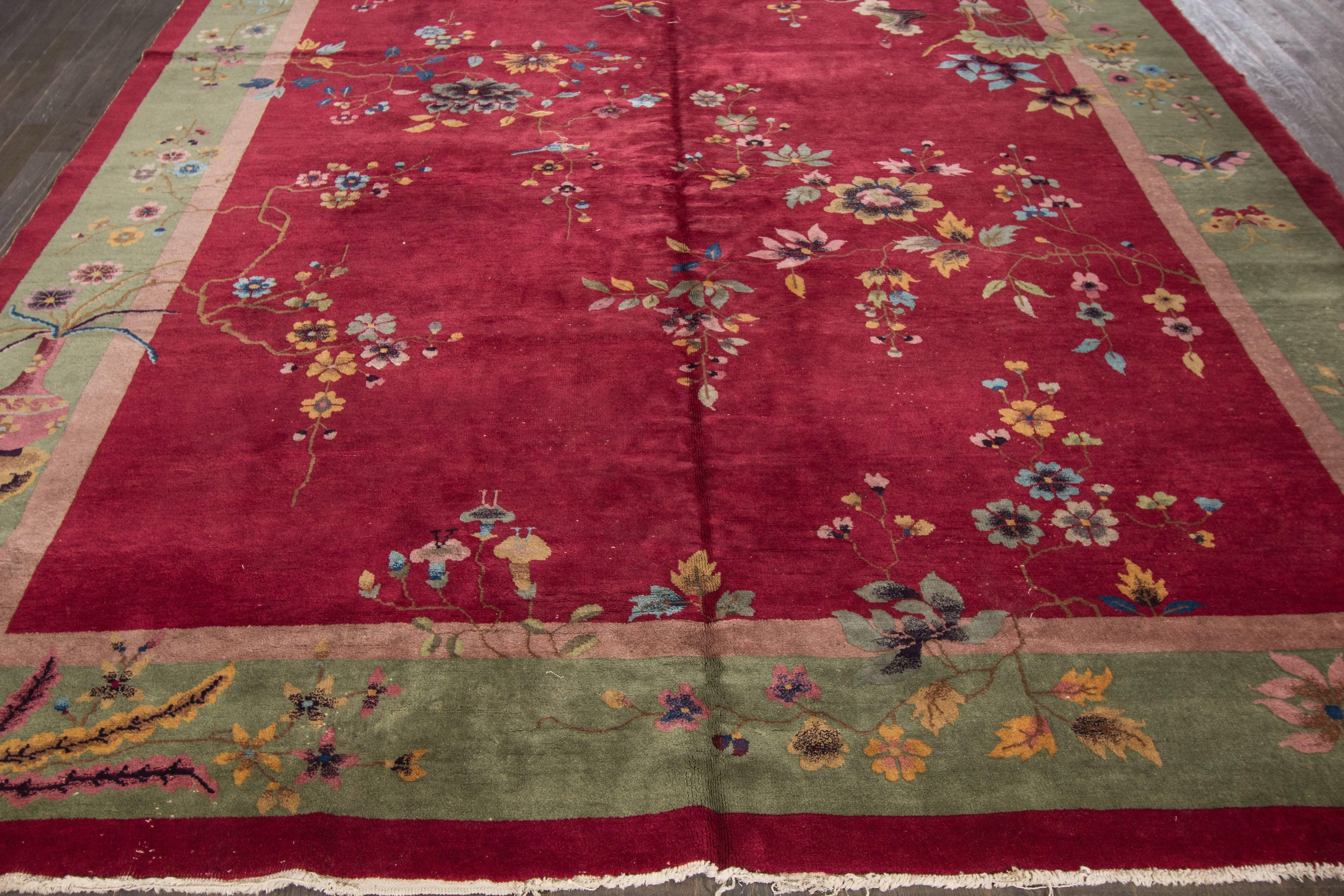Antique Chinese deco with a floral design on a red field.
Material: Wool. Measures: 9' x 12'.