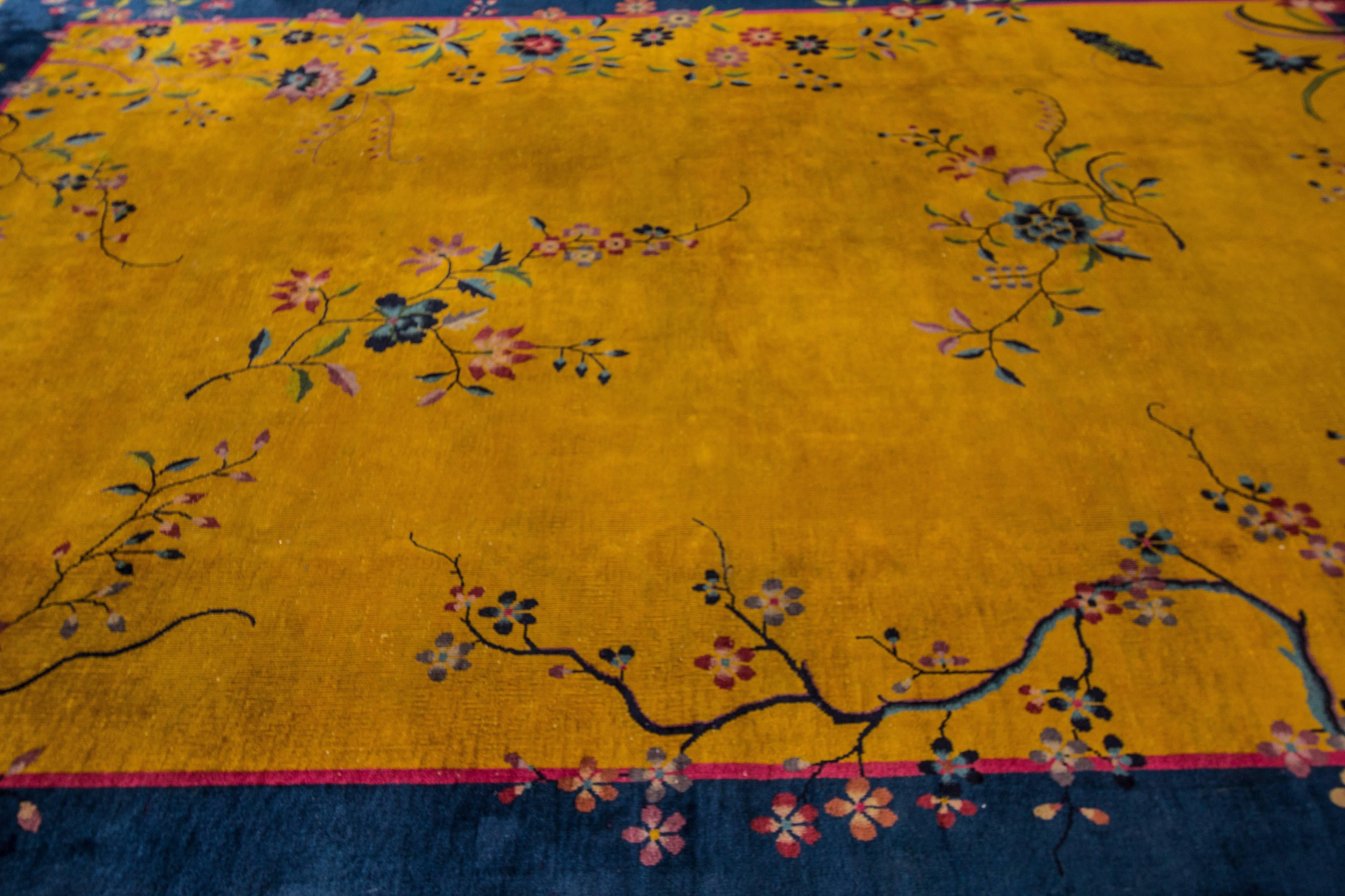 Beautiful Chinese Art Deco hand-knotted wool rug with a yellow field blue frame and multi-color accents in all-over Chinese botanical designs.

This rug measure: 8' x 11'.