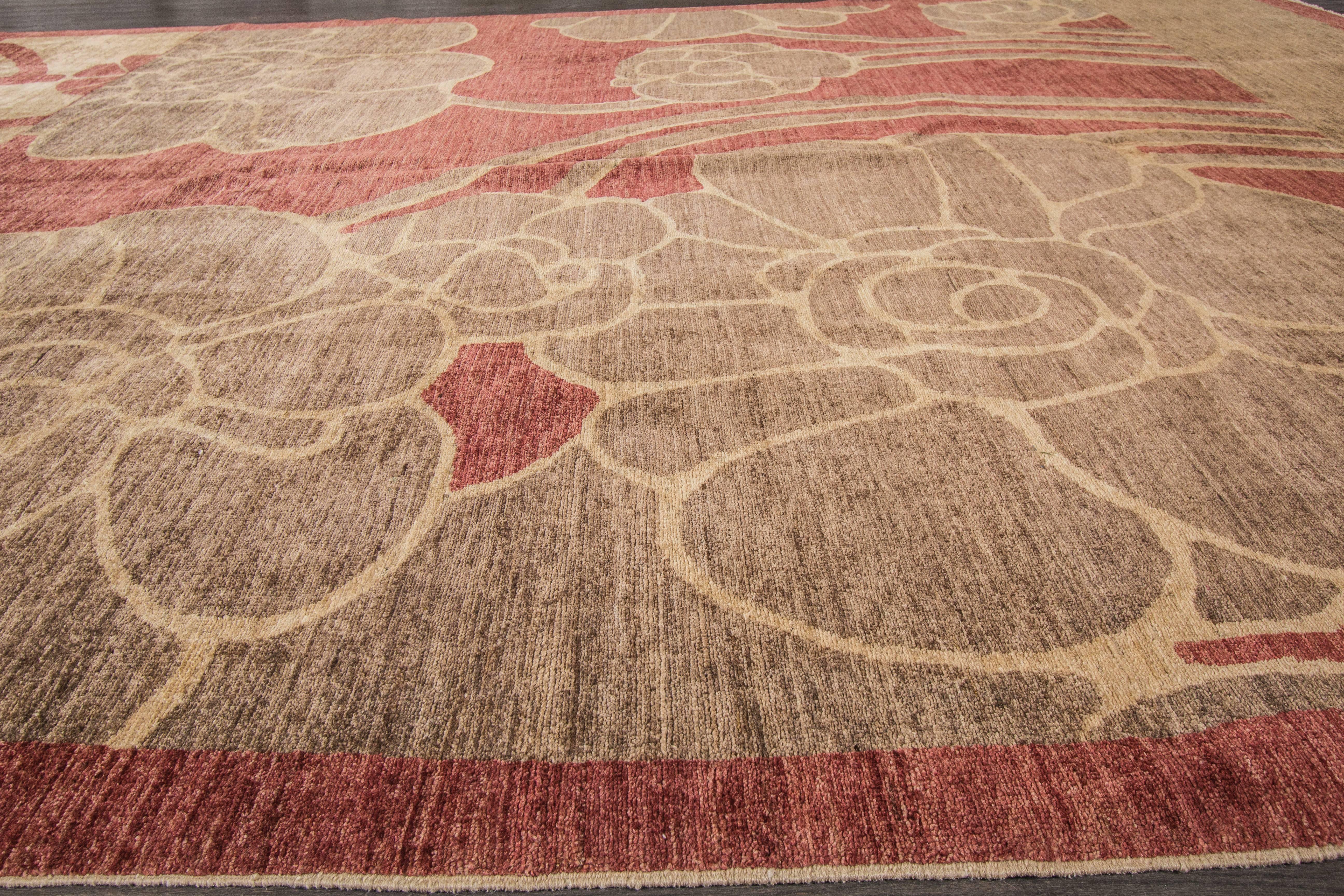 Modern contemporary hand-knotted rug with a floral design on a red field. 

This rug has magnificent detailing and would be perfect for any room. Measures: 8'3