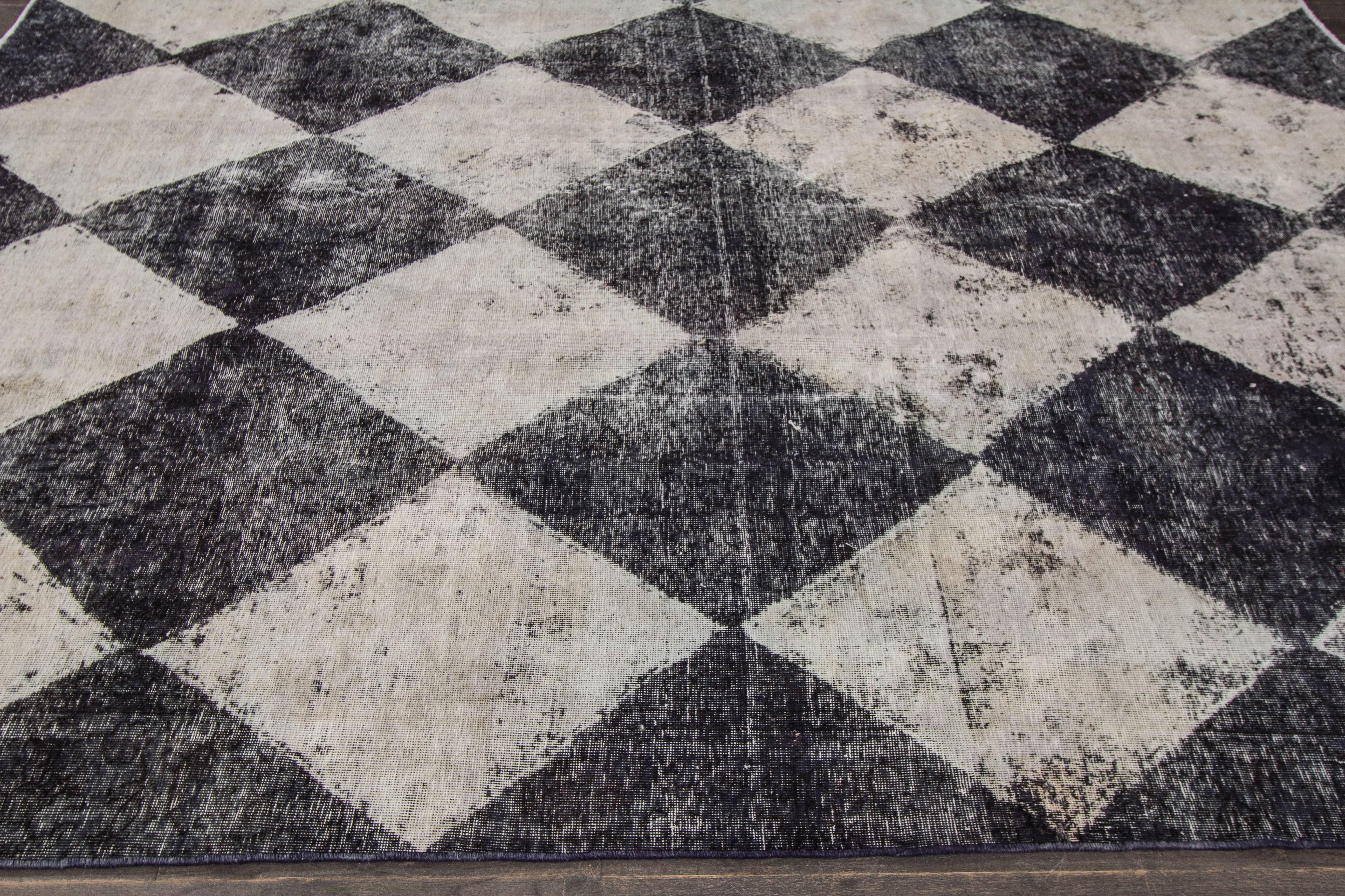 Vintage hand-knotted rug with a geometric design on an ivory and grey field with blue borders. Measures: 8' x 10'. 

This rug has magnificent detailing and would be perfect for any room.