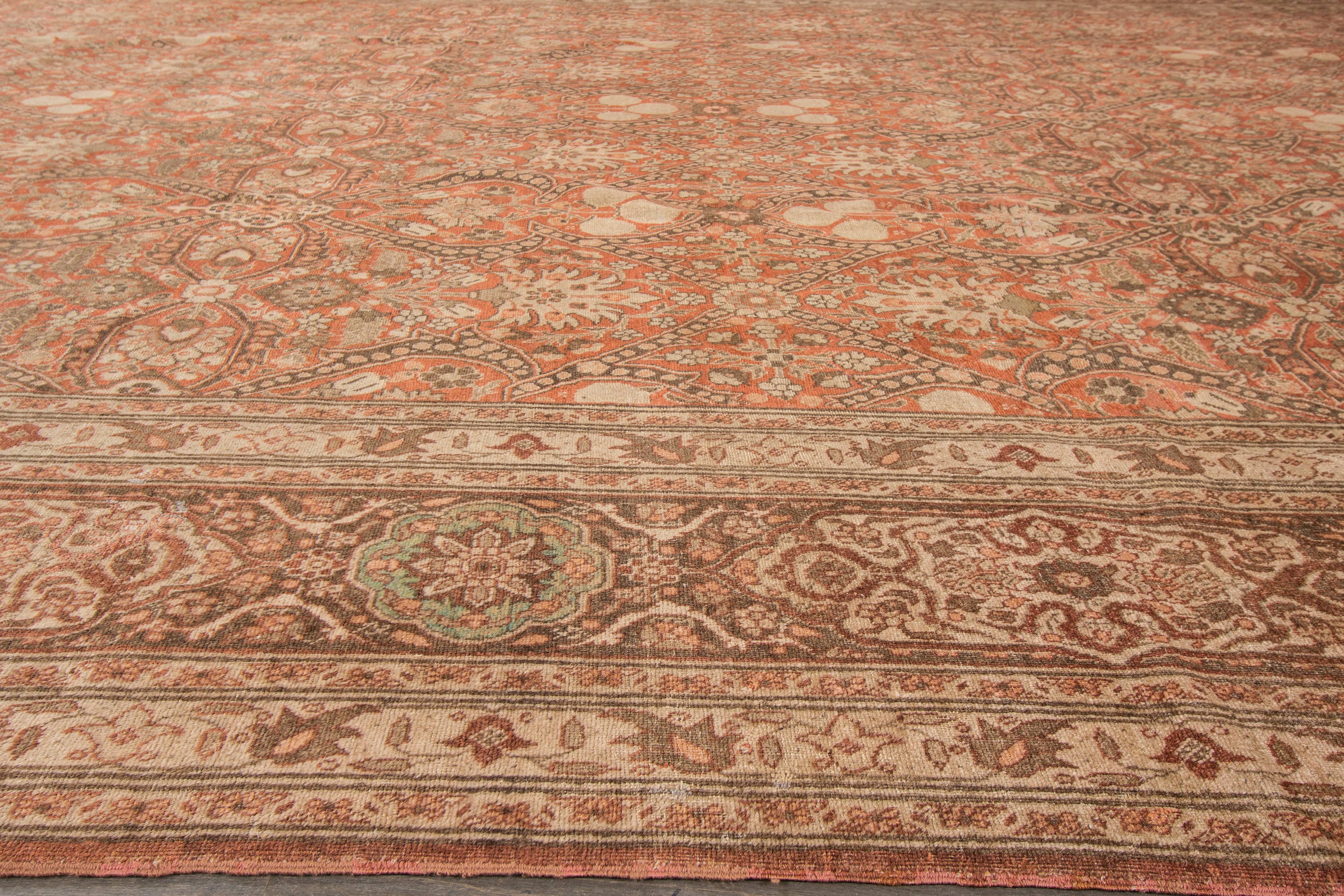 Hand-knotted rug with a floral design on a rust field. 

This rug has magnificent detailing and would be perfect for any room. Measures: 12' x 19'.