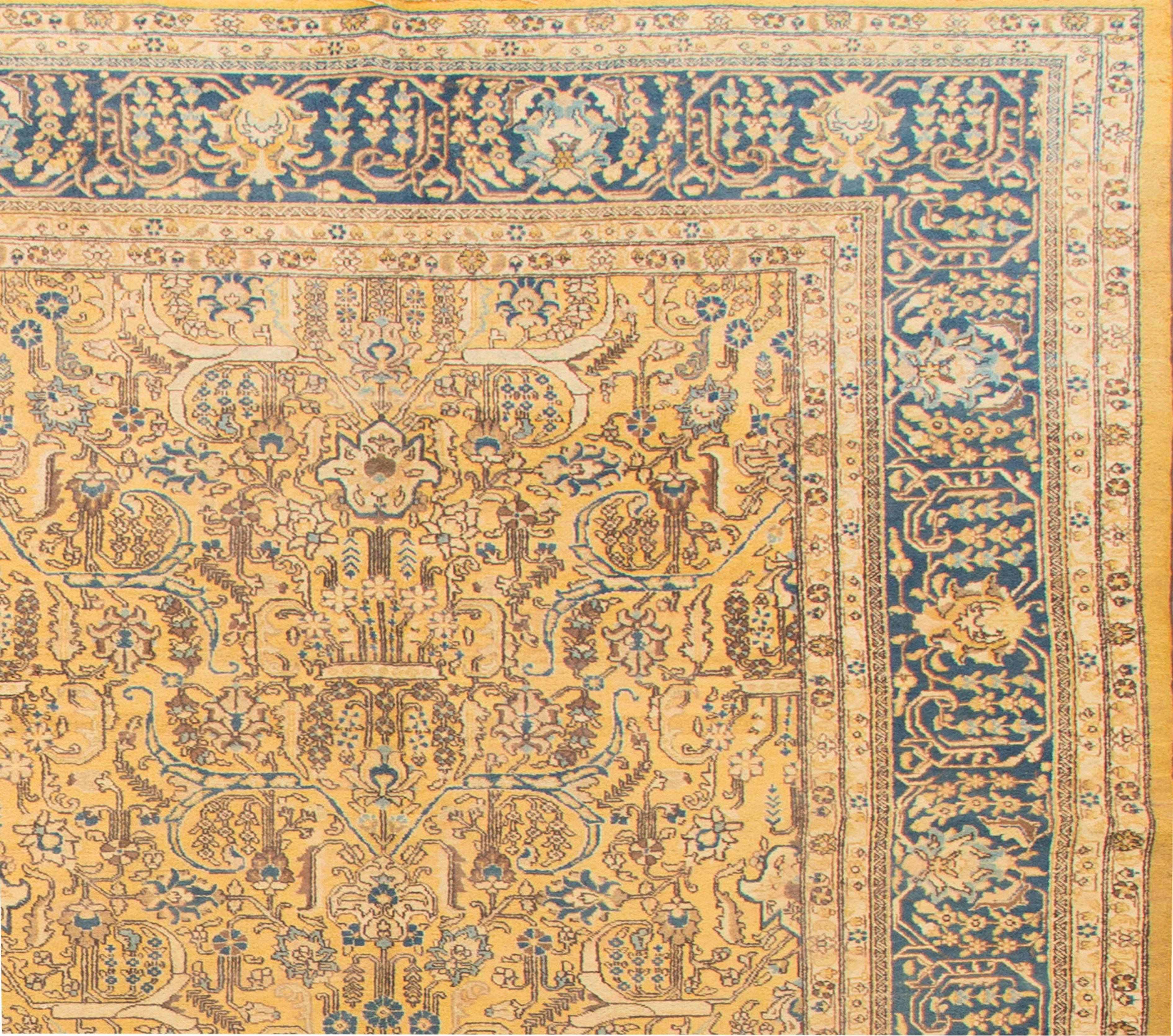 Antique Tabriz Persian carpet, yellow field with blue and earth tone floral accents. Measures: 12 x 16.10.