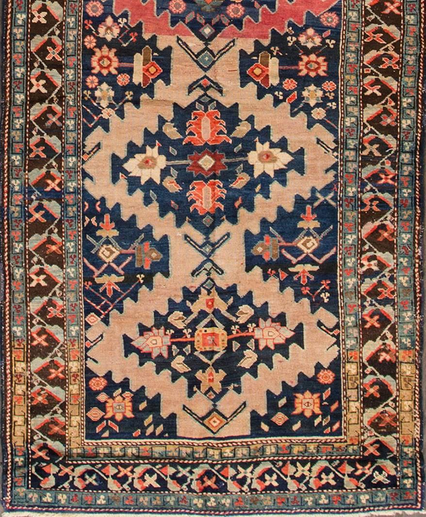 Early 1900s Russian Karabagh rug with a brown border, multicolored design, and rose accents throughout. Measures: 3.09 x 17.04.