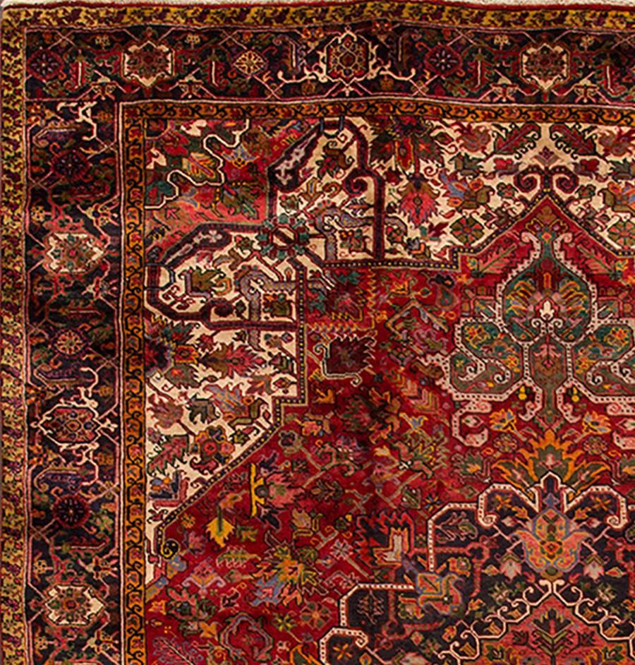 Beautiful Vintage Persian Heriz hand-knotted wool rug with a rust field. This rug has a brown frame and multi-color accents in traditional center medallion design. 

This rug measures: 9'9