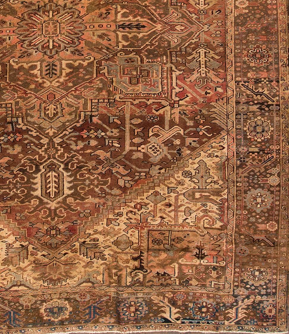 Vintage 1960s Persian Heriz carpet with a brown or tan field, traditional medallion design. Measure: 10 x 13.