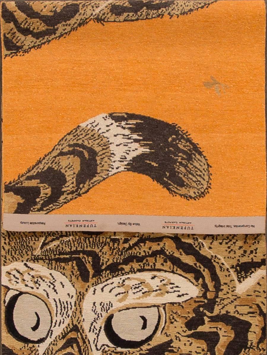 21st century contemporary Tibetan rug with an orange field and a tiger design (pictorial). Measures 3x10. 