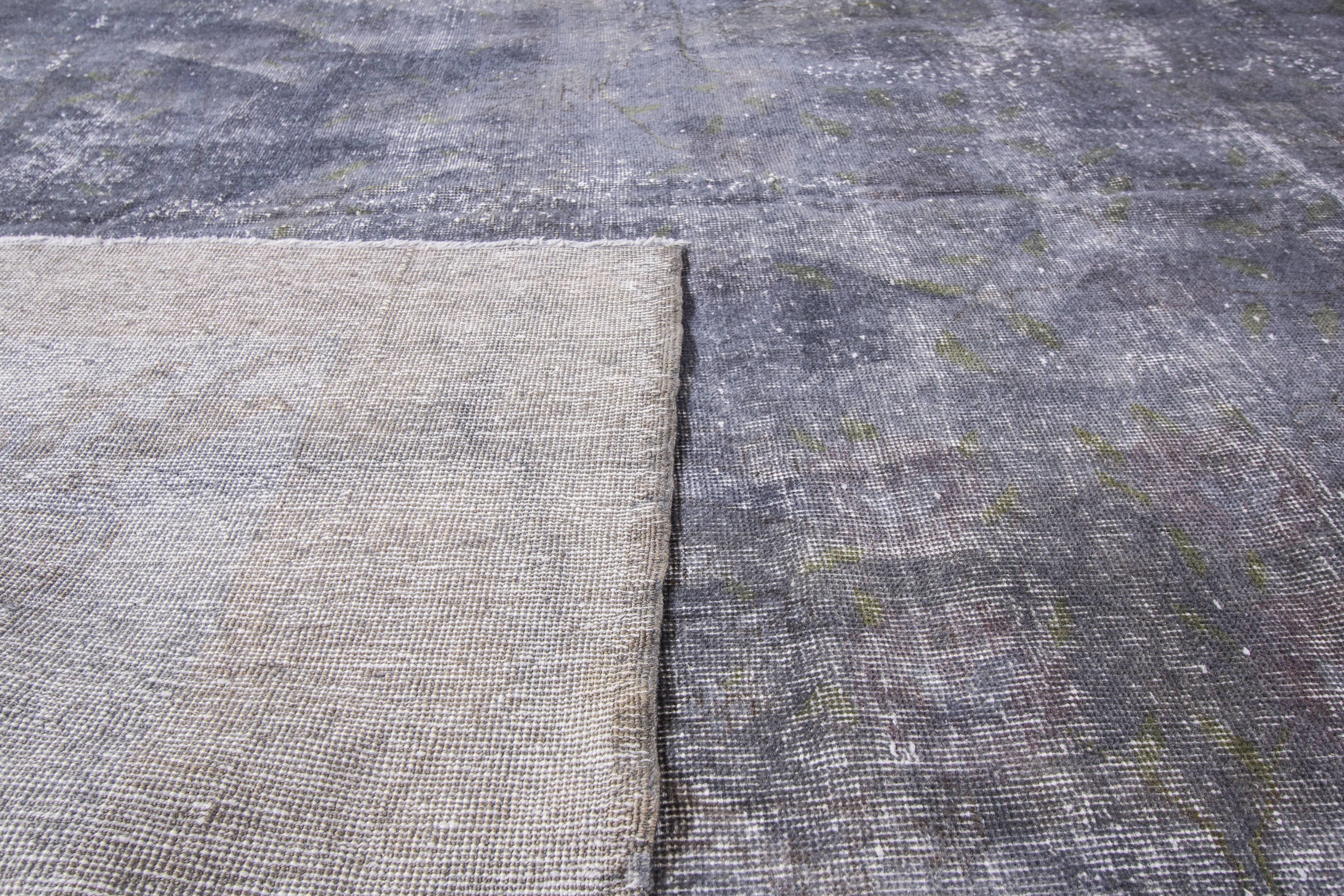 Hand-knotted mid-20th century (1960s) Pakistani rug with a grey overdyed field. Has a very faint border design, visible through the dye. Measures 10.02x13.01.