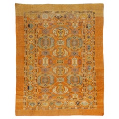 Tappeto in lana in stile vintage revival nei vivaci toni dell'arancione zafferano e delle calde tonalità della terra