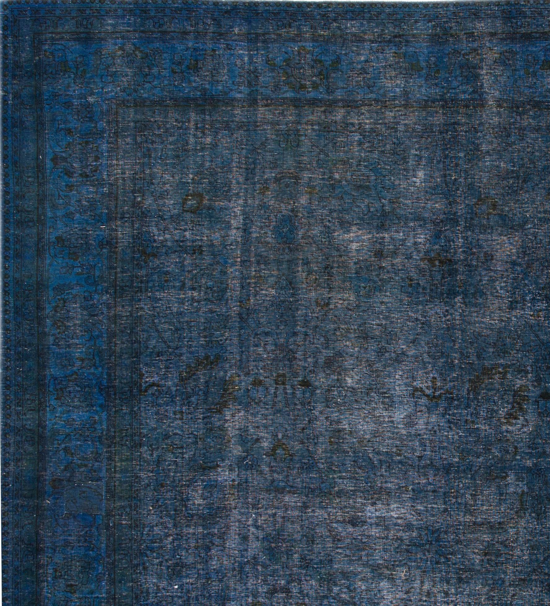 Vintage 1960s hand-knotted overdyed Persian carpet with a dark blue field and floral border. Measures 12.04x13.
